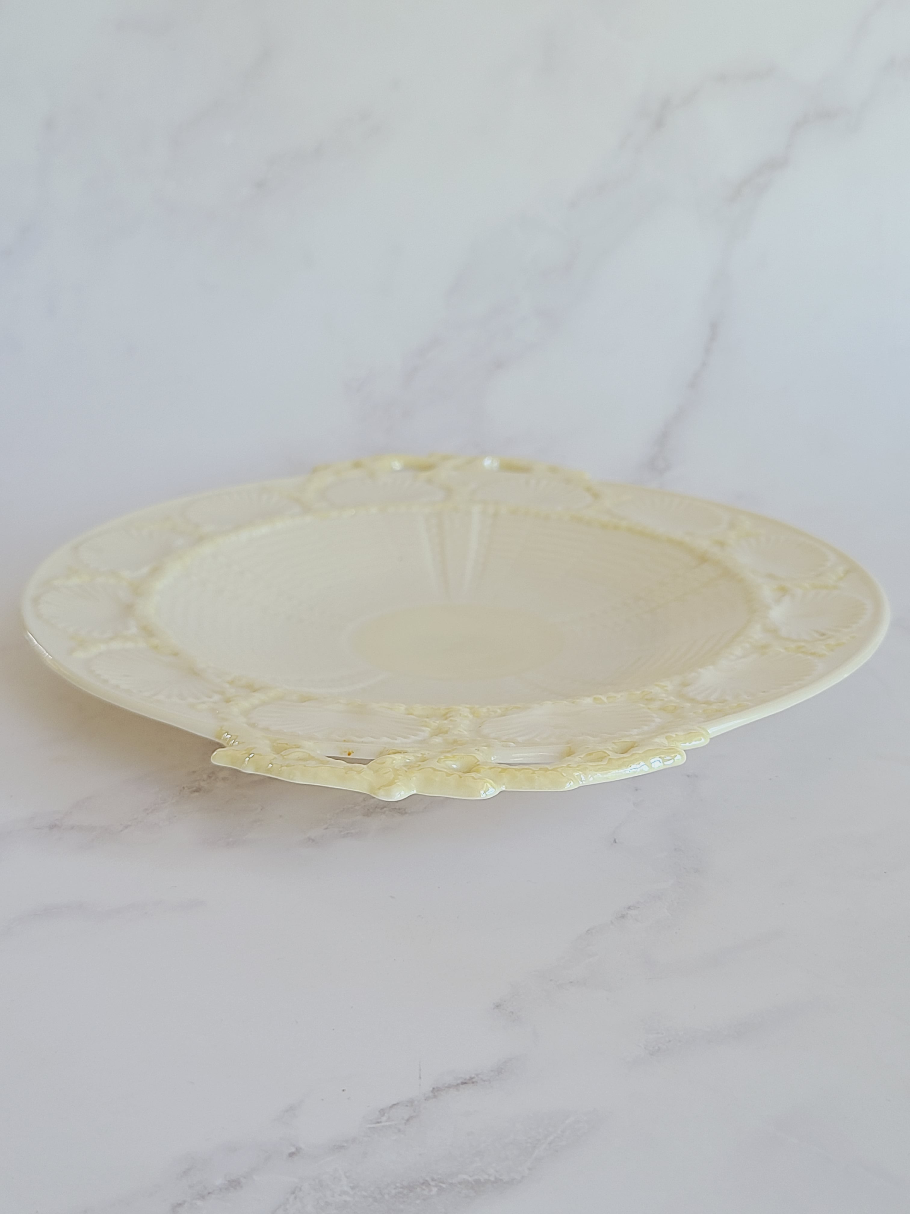Vintage Belleek Porcelain Plate with Shell Motif shown from side