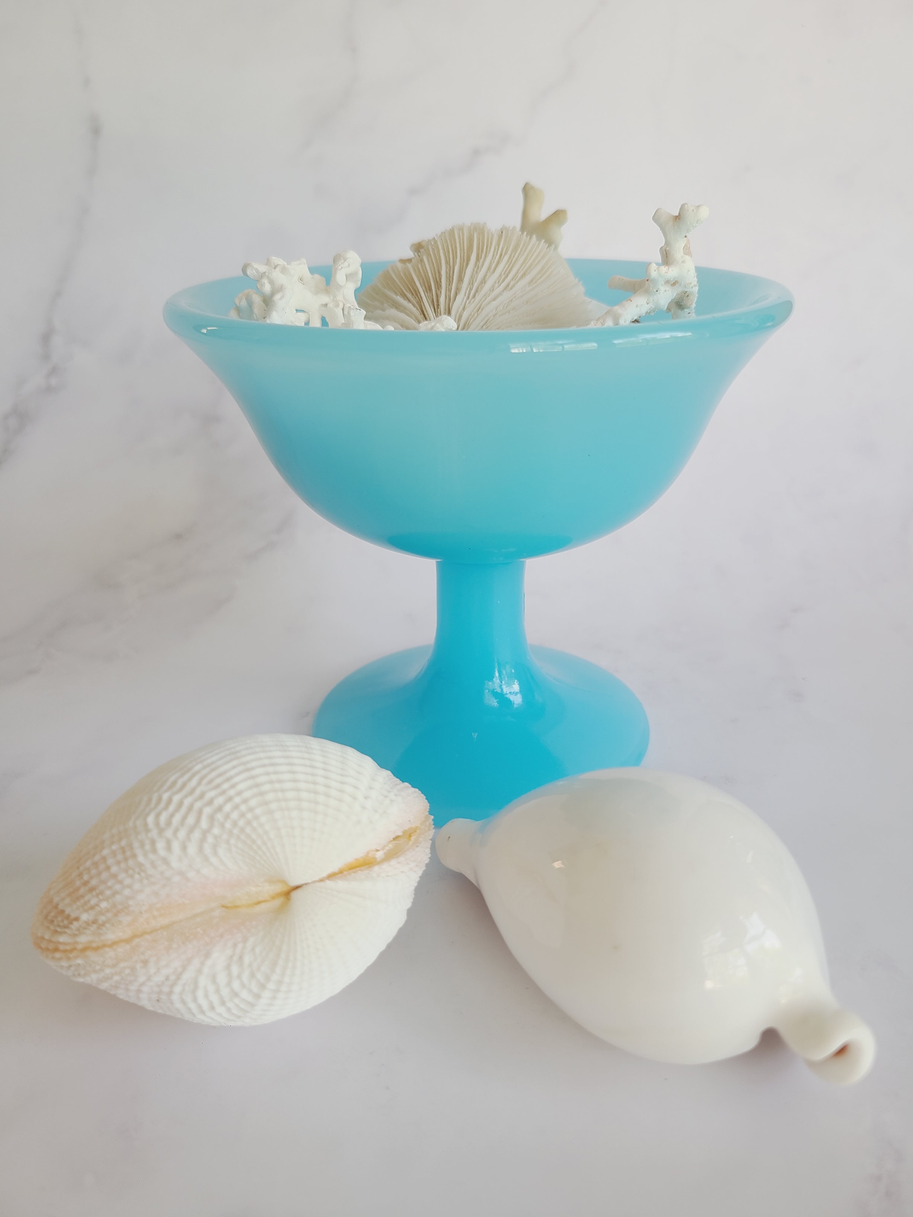Vintage Fenton Glass Compote in Opaque Turquoise displayed with seashells.