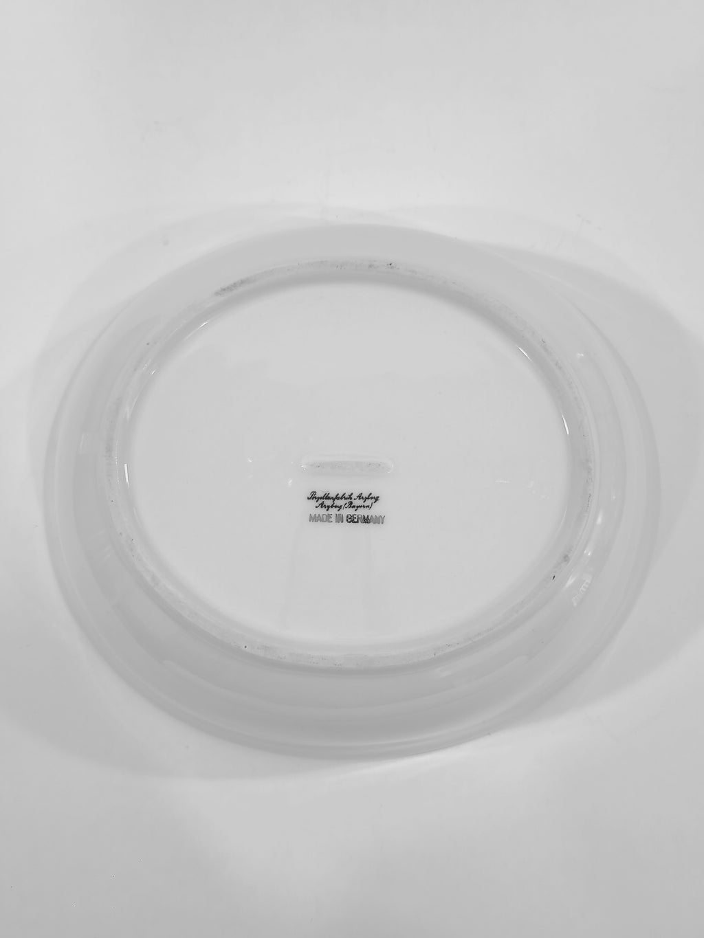 Bottom of Vintage white porcelain Arzberg Form 1382 Oval Vegetable Bowl by Hermann Gretsch on white background.