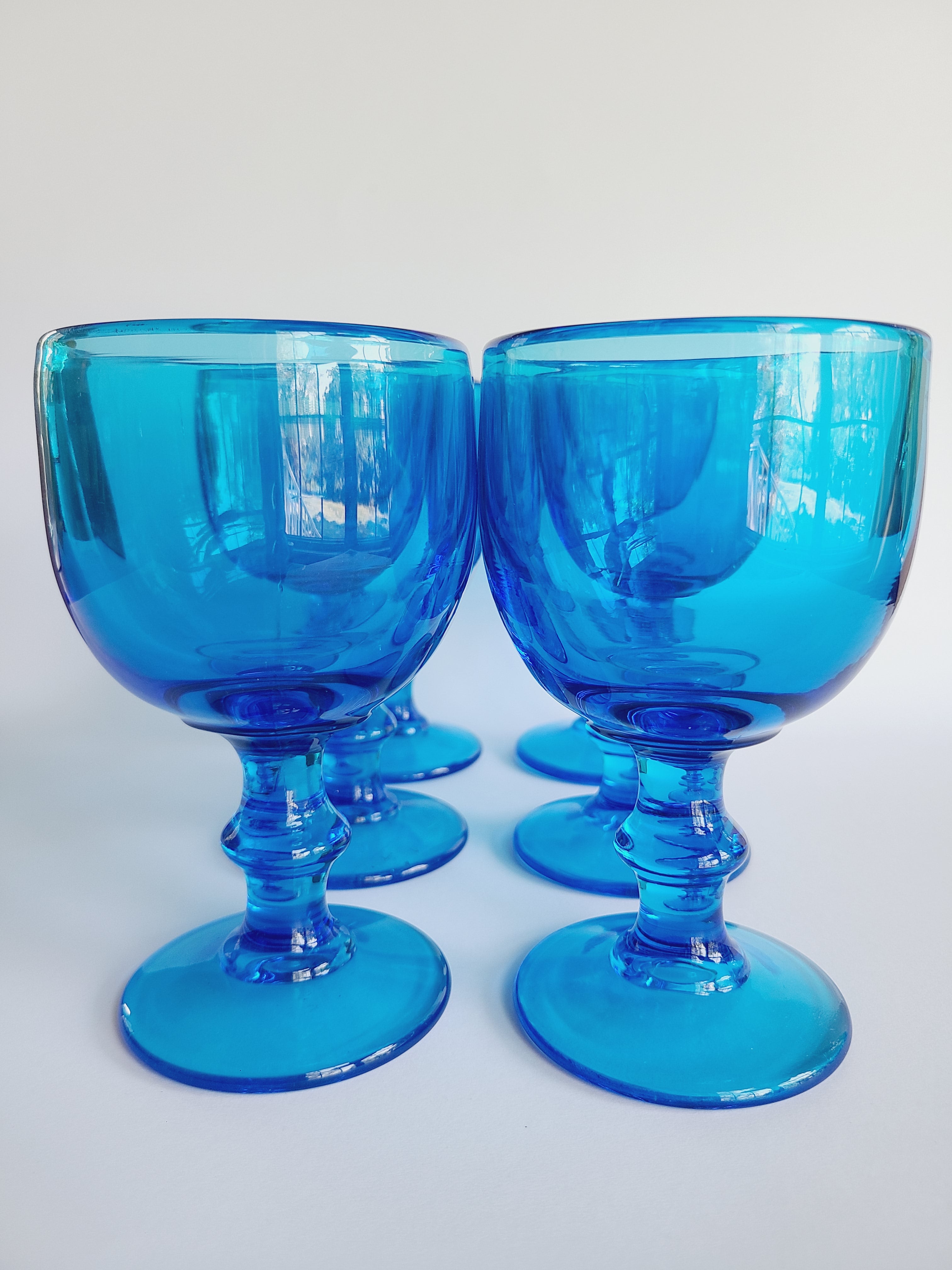 Set of 6 vintage turquoise glass goblets by Imperial Glass Hoffman House on white background.