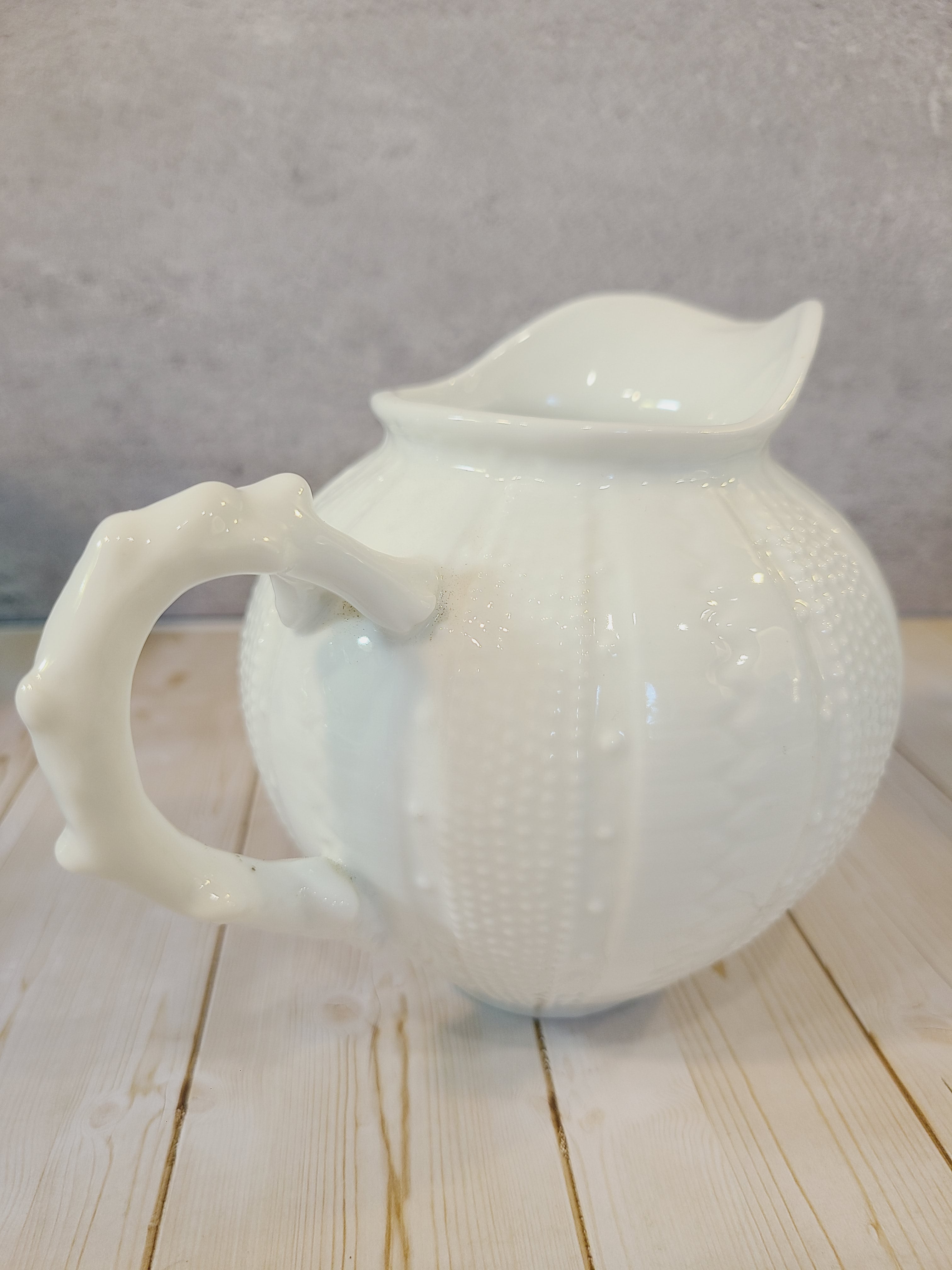 Vintage Paris Royal pitcher or creamer with sea urchin design highlighting handle.