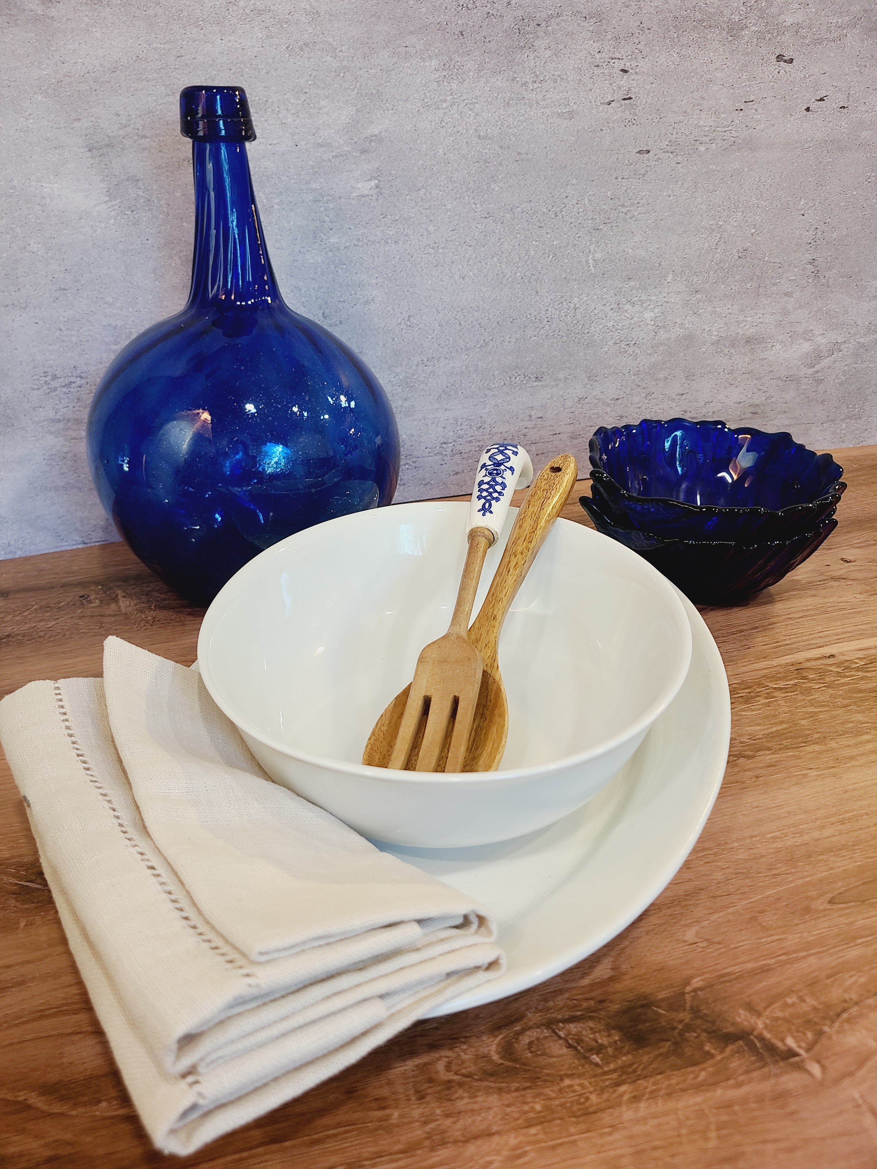 Vintage white porcelain Arzberg Form 1382 Oval Vegetable Bowl by Hermann Gretsch displayed with blue glass items.