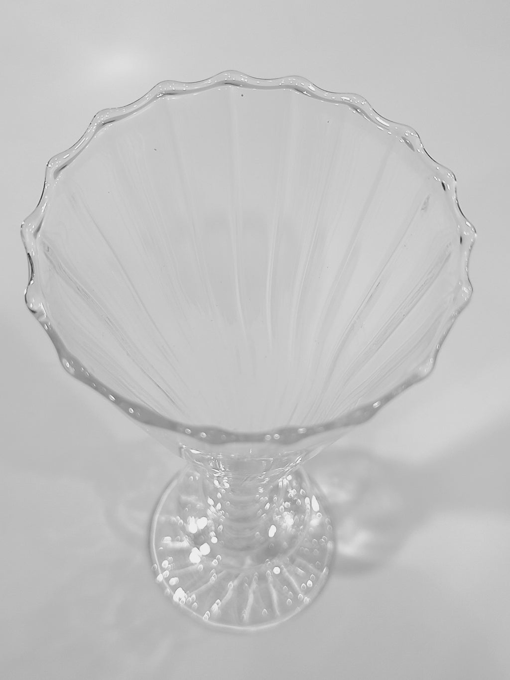 Close up of rim of clear glass vase.