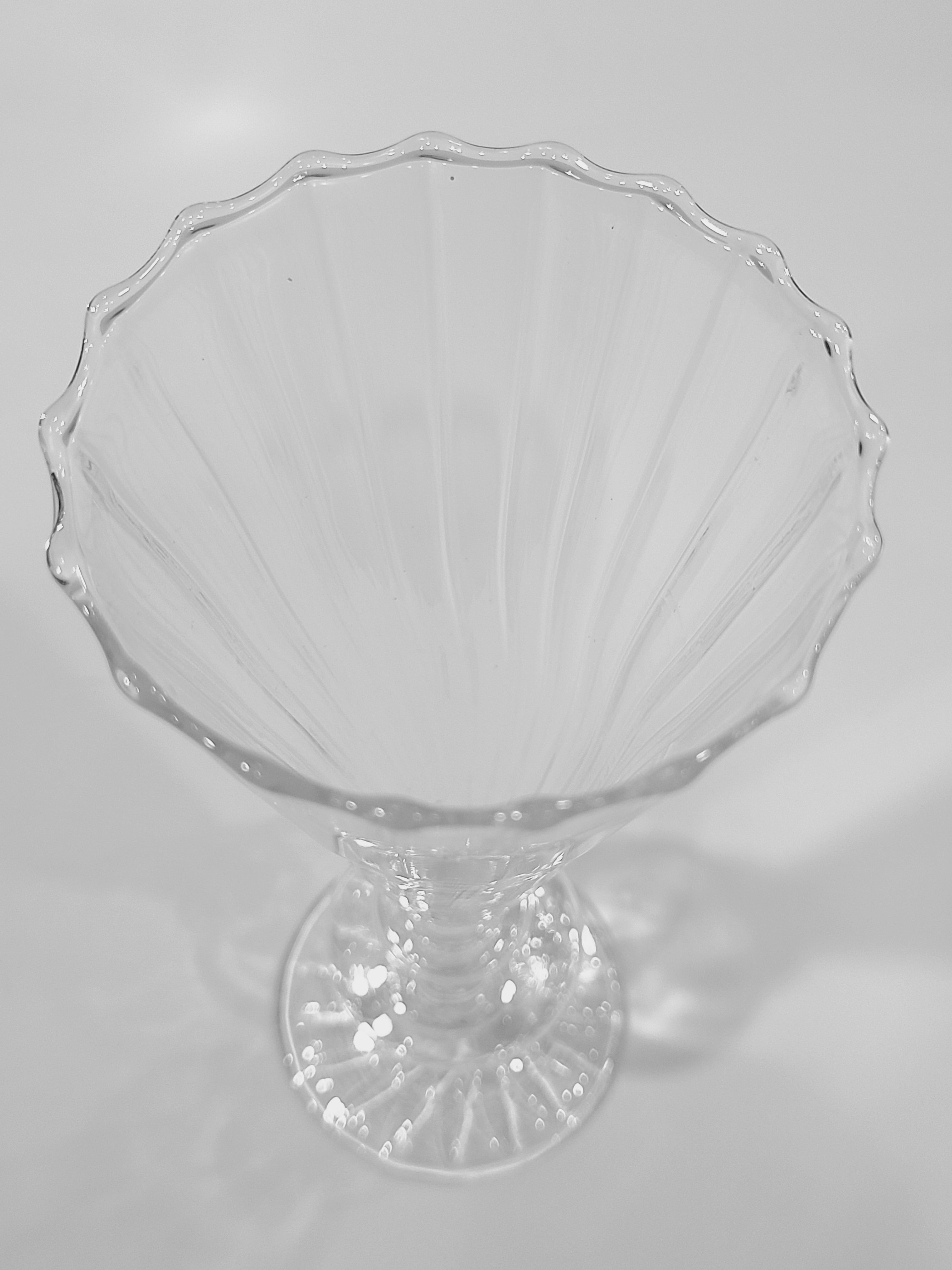 Close up of rim of clear glass vase.