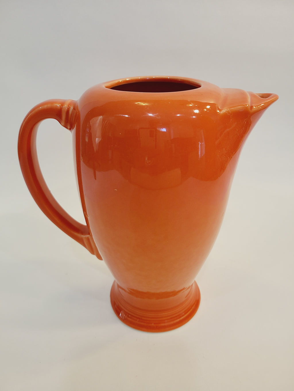 Fiesta carafe in color Persimmon set against plain white background.