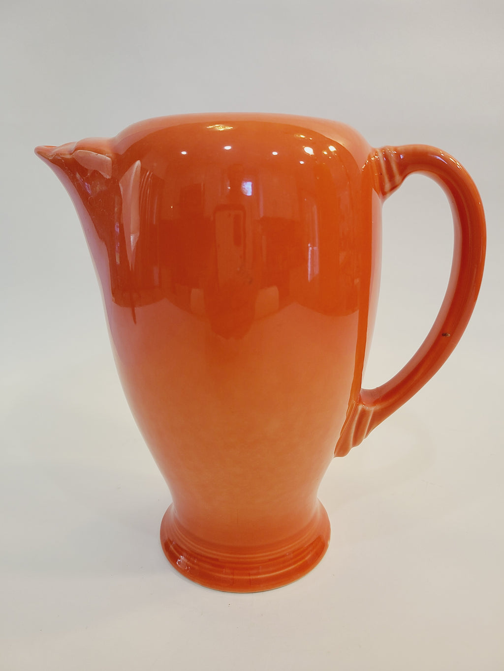 Fiesta carafe in color Persimmon shown from the side.