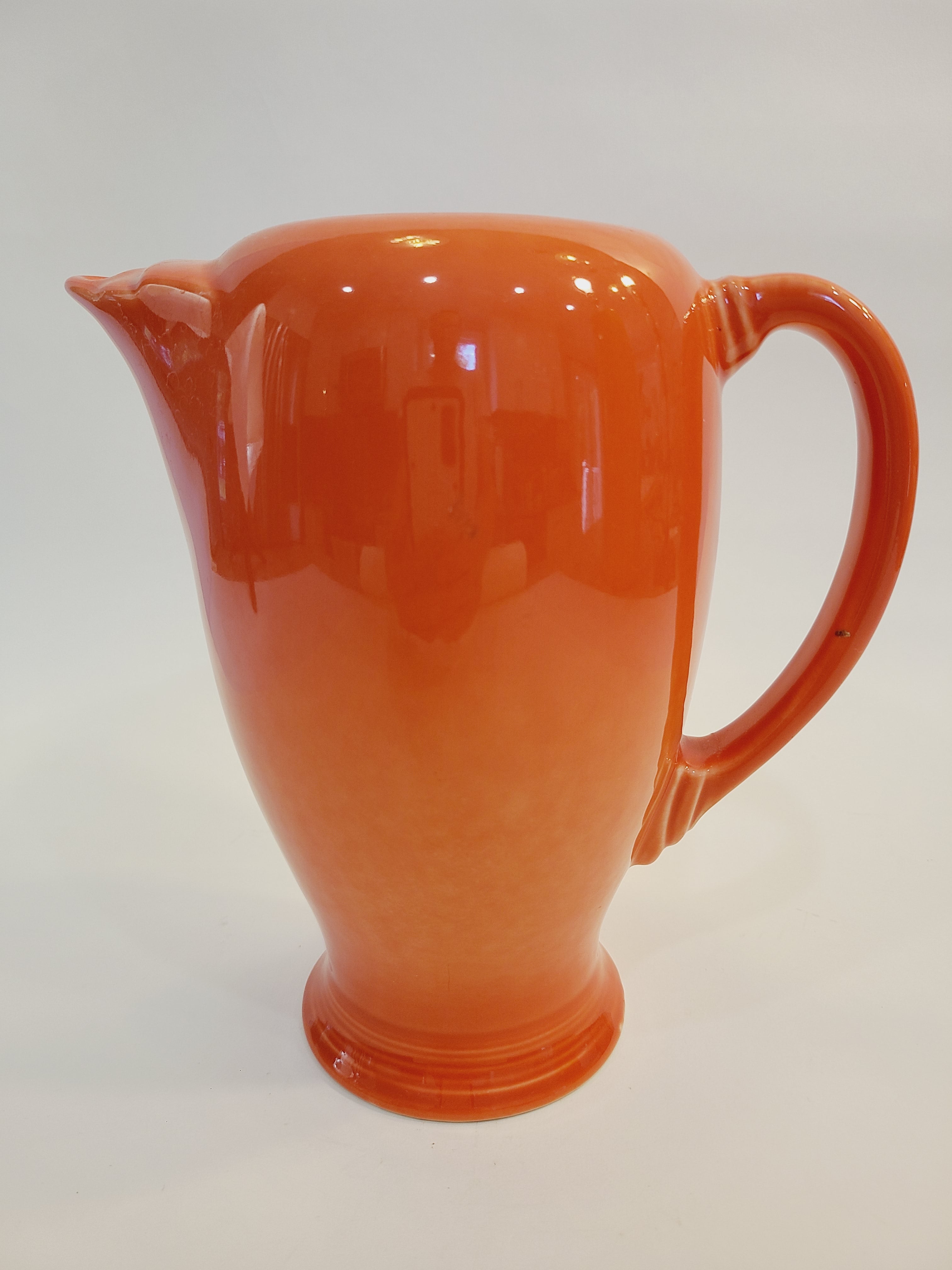 Fiesta carafe in color Persimmon shown from the side.