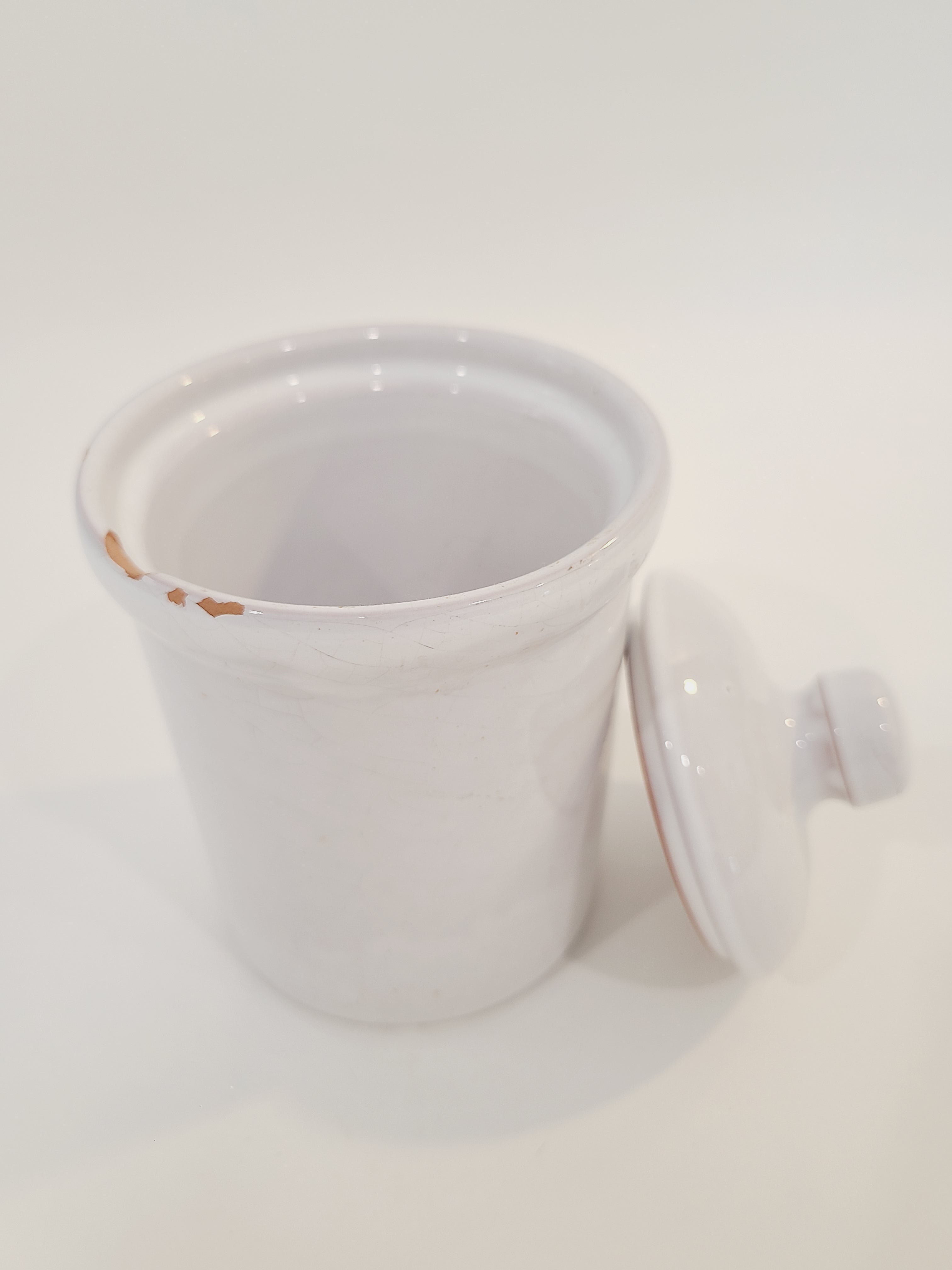 A white ceramic lidded crock with a glossy finish, photographed against a plain white background.
