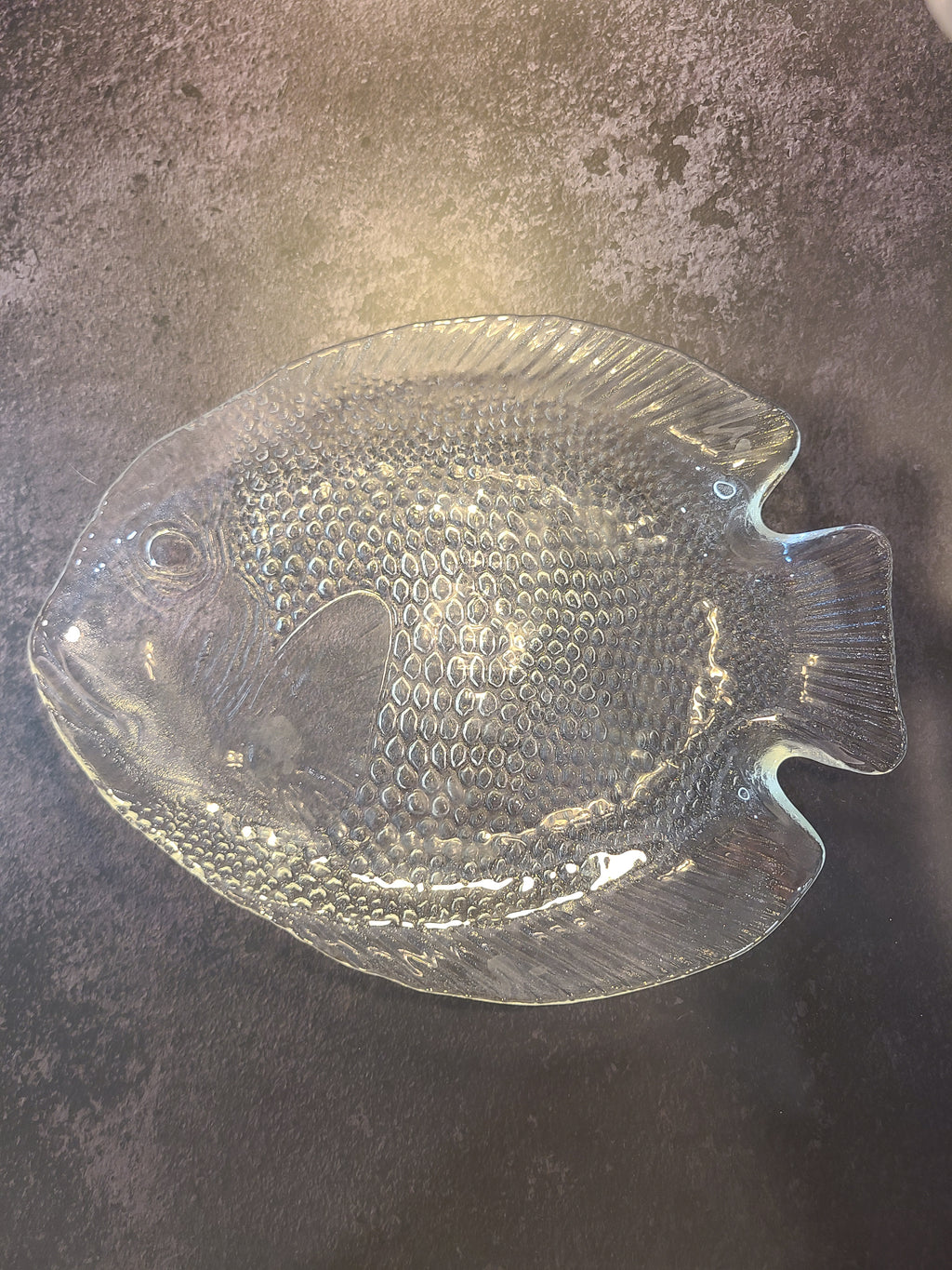 A vintage Arcoroc clear glass fish-shaped plate made in France with a textured, embossed pattern.