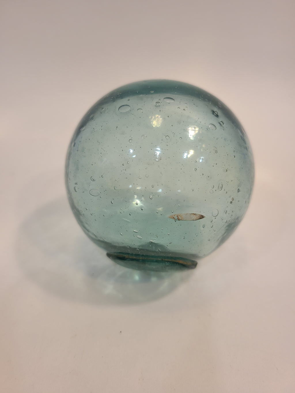 Authentic Glass Fishing Float 3" diameter in classic blue-green color showing bubbles and imperfections on surface.