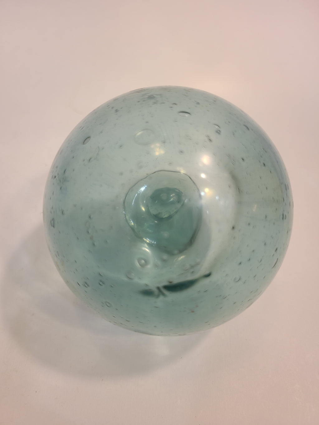 Close up of Authentic Glass Fishing Float 3" diameter in classic blue-green color.