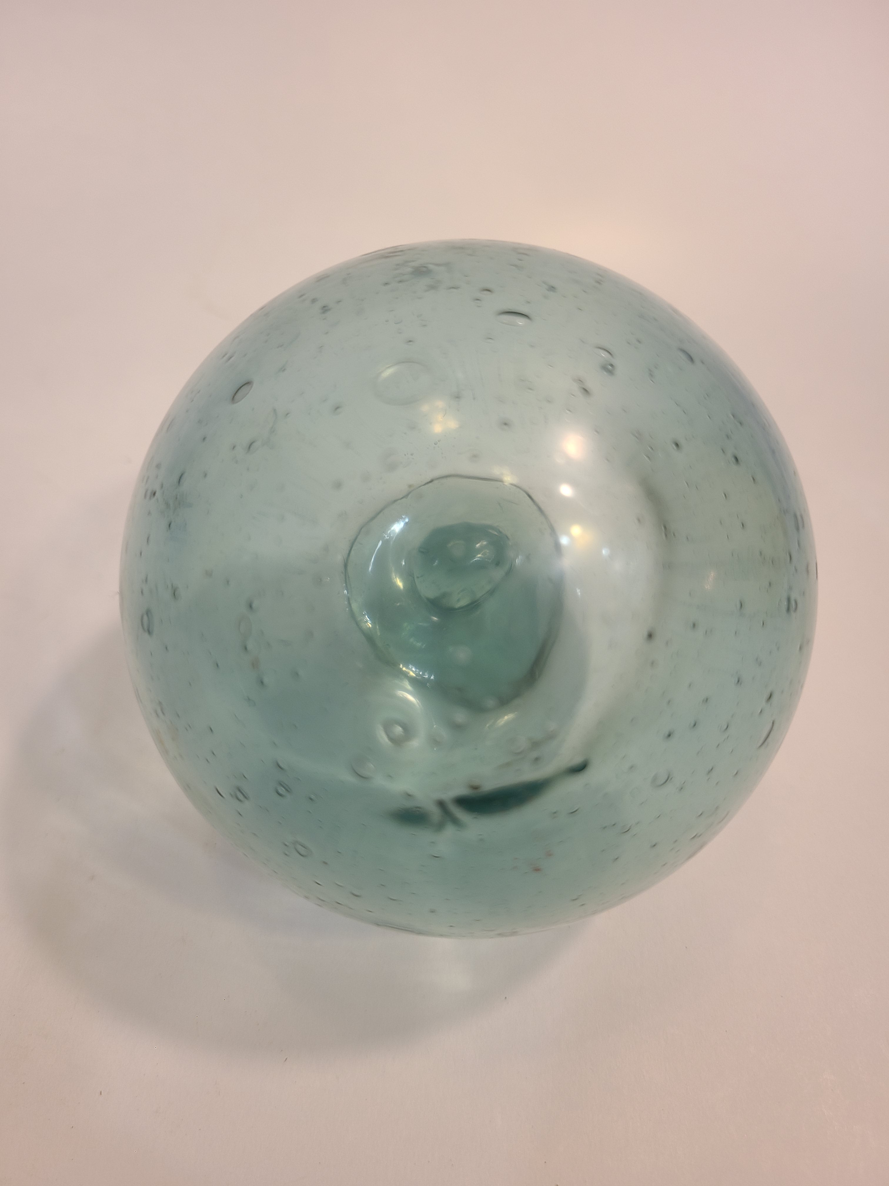 Close up of Authentic Glass Fishing Float 3" diameter in classic blue-green color.