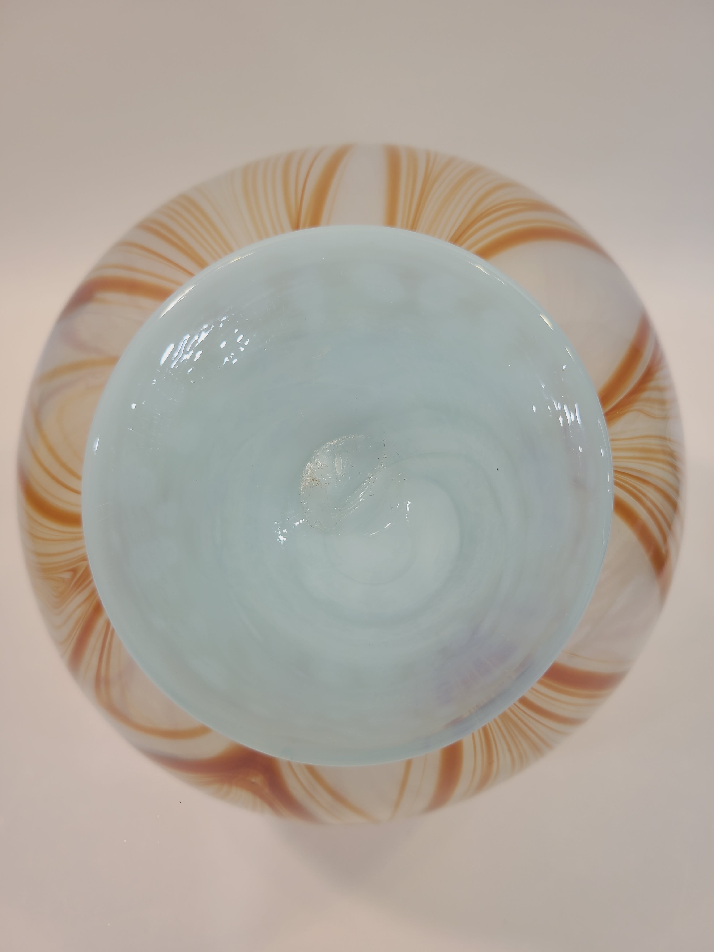 Base of Handblown artisan glass vase in shape of a sphere, very pale aqua with orange feather-raked accents, 7 inches diameter.