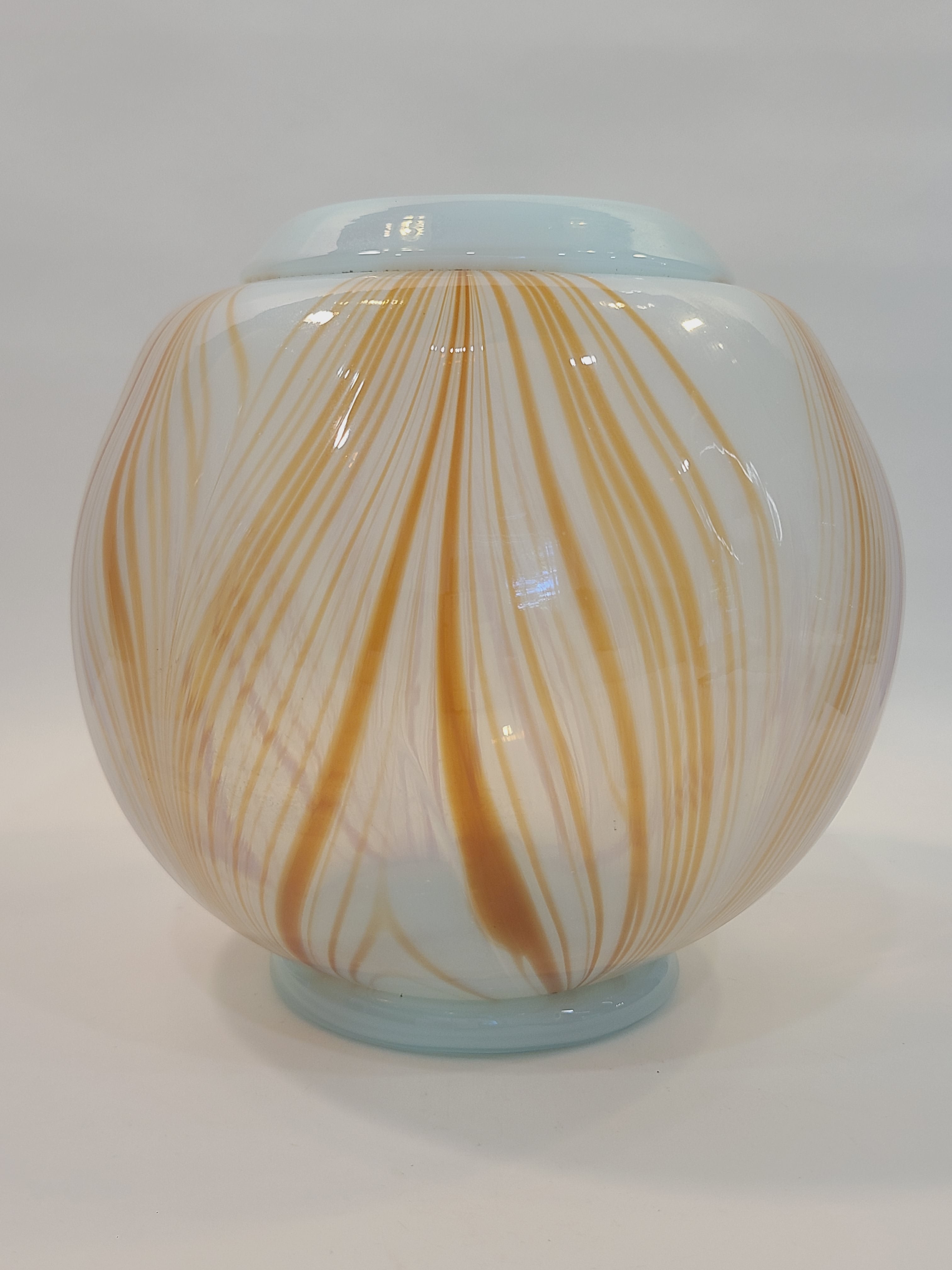 Handblown artisan glass vase in shape of a sphere, very pale aqua with orange feather-raked accents, 7 inches diameter.