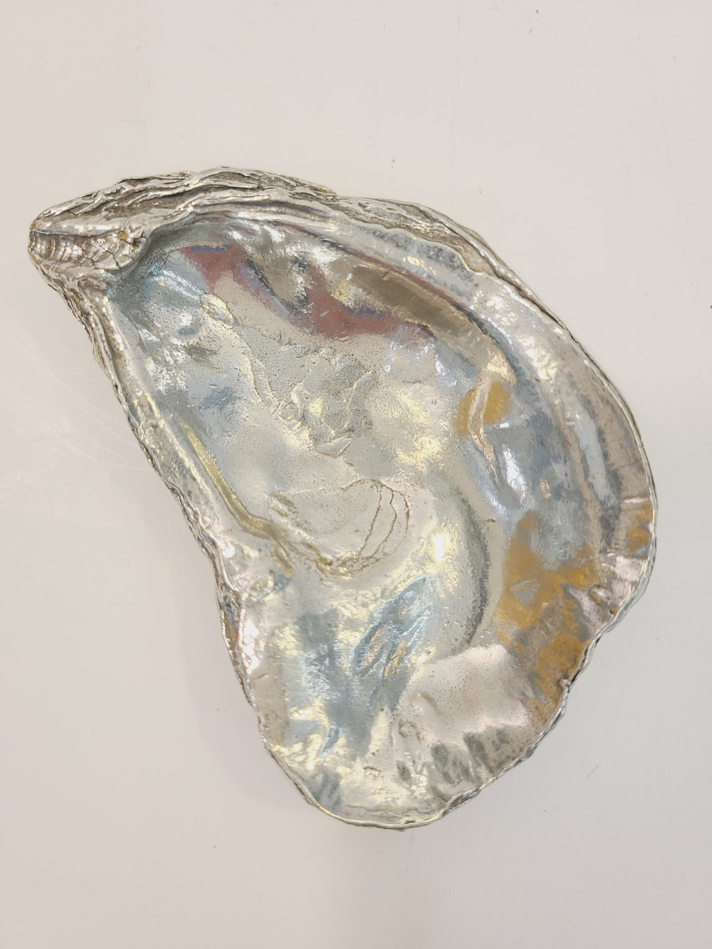 Pewter oyster shell dish, 3.75 inches by 2.25 inches.