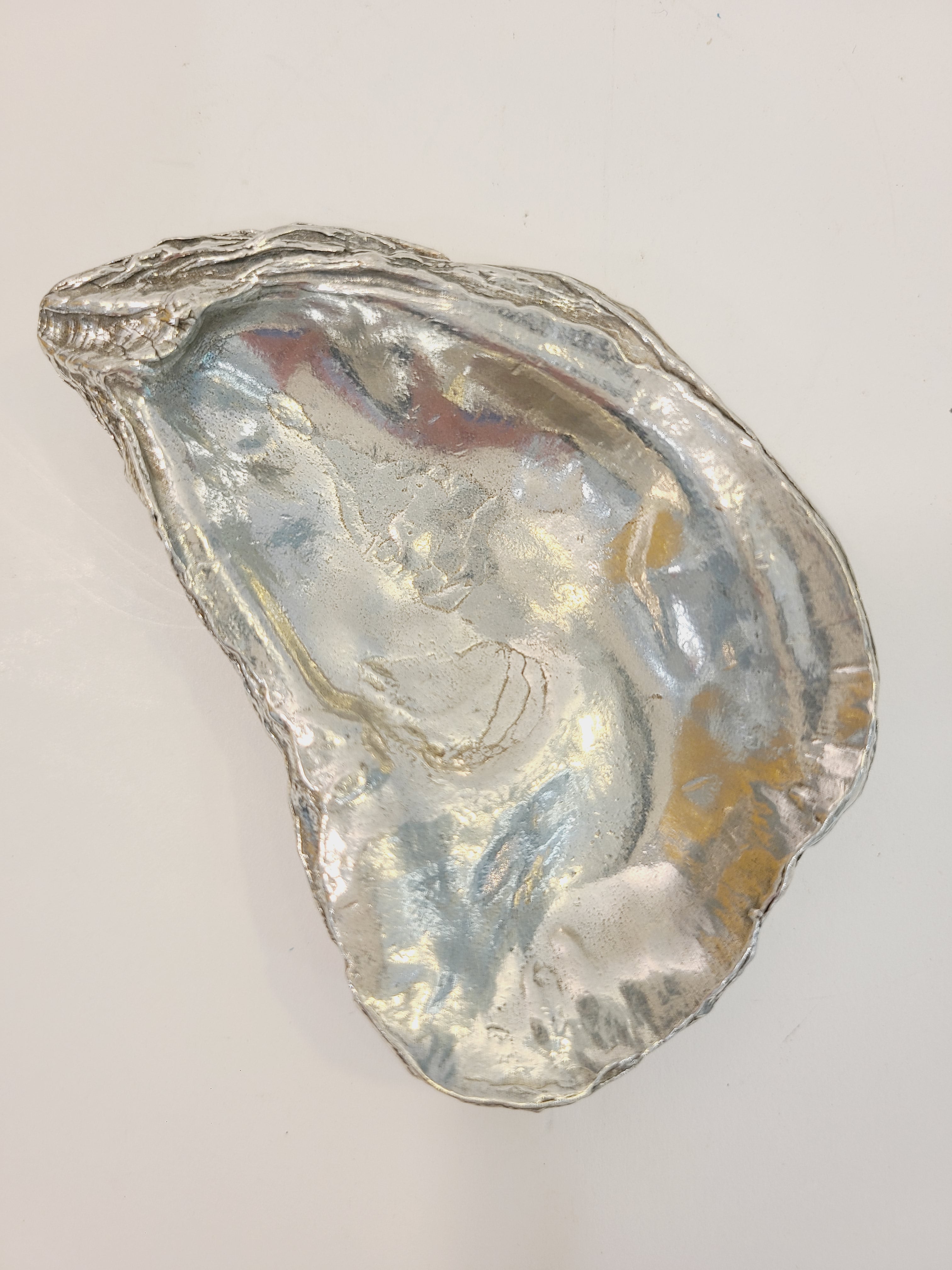 Pewter oyster shell dish, 3.75 inches by 2.25 inches.