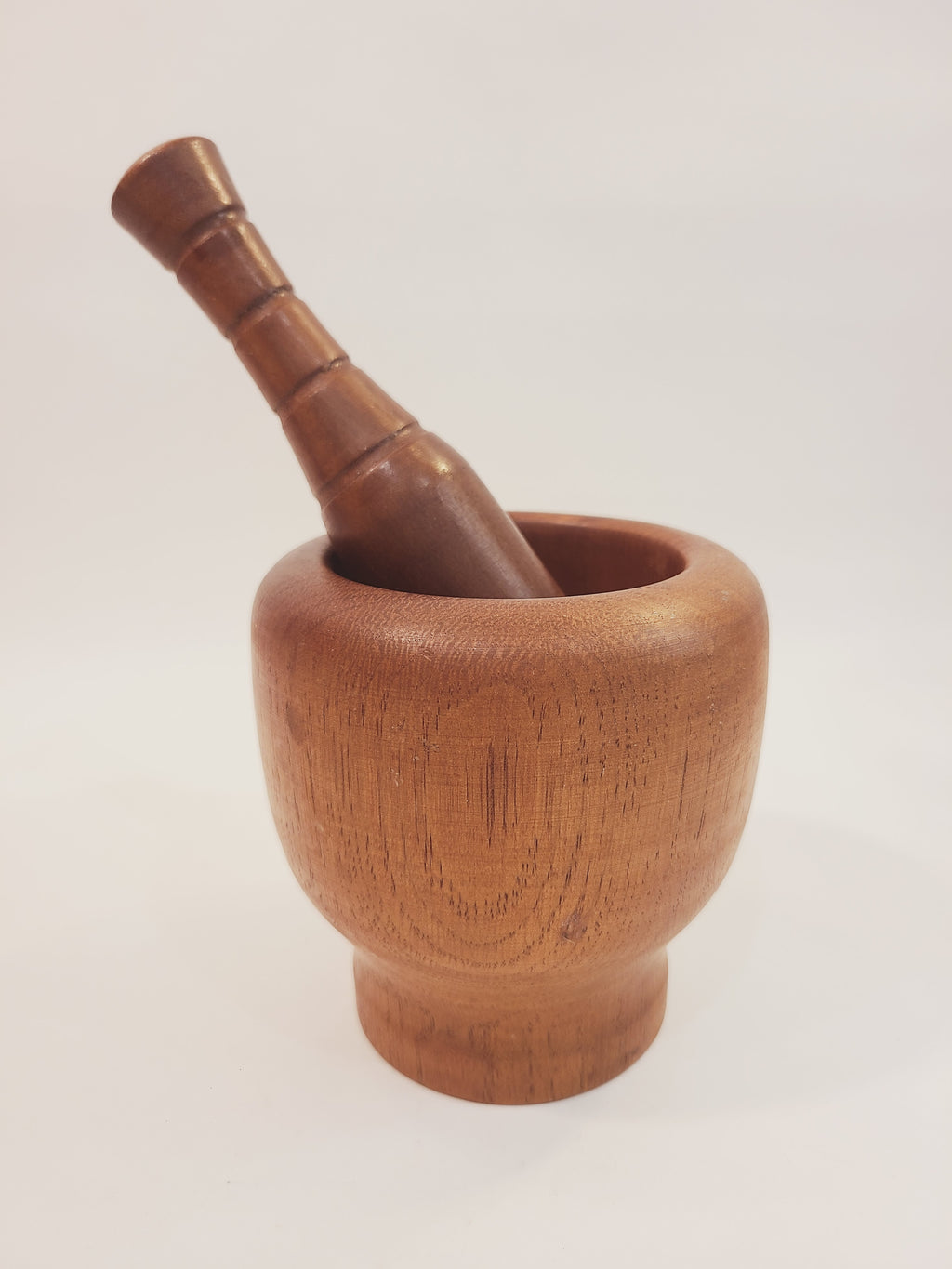 Antique Turned Wood Mortar and Pestle, Mortar 4.25 inches high by 4.25 inches diameter; Pestle 6 inches high, on light background.