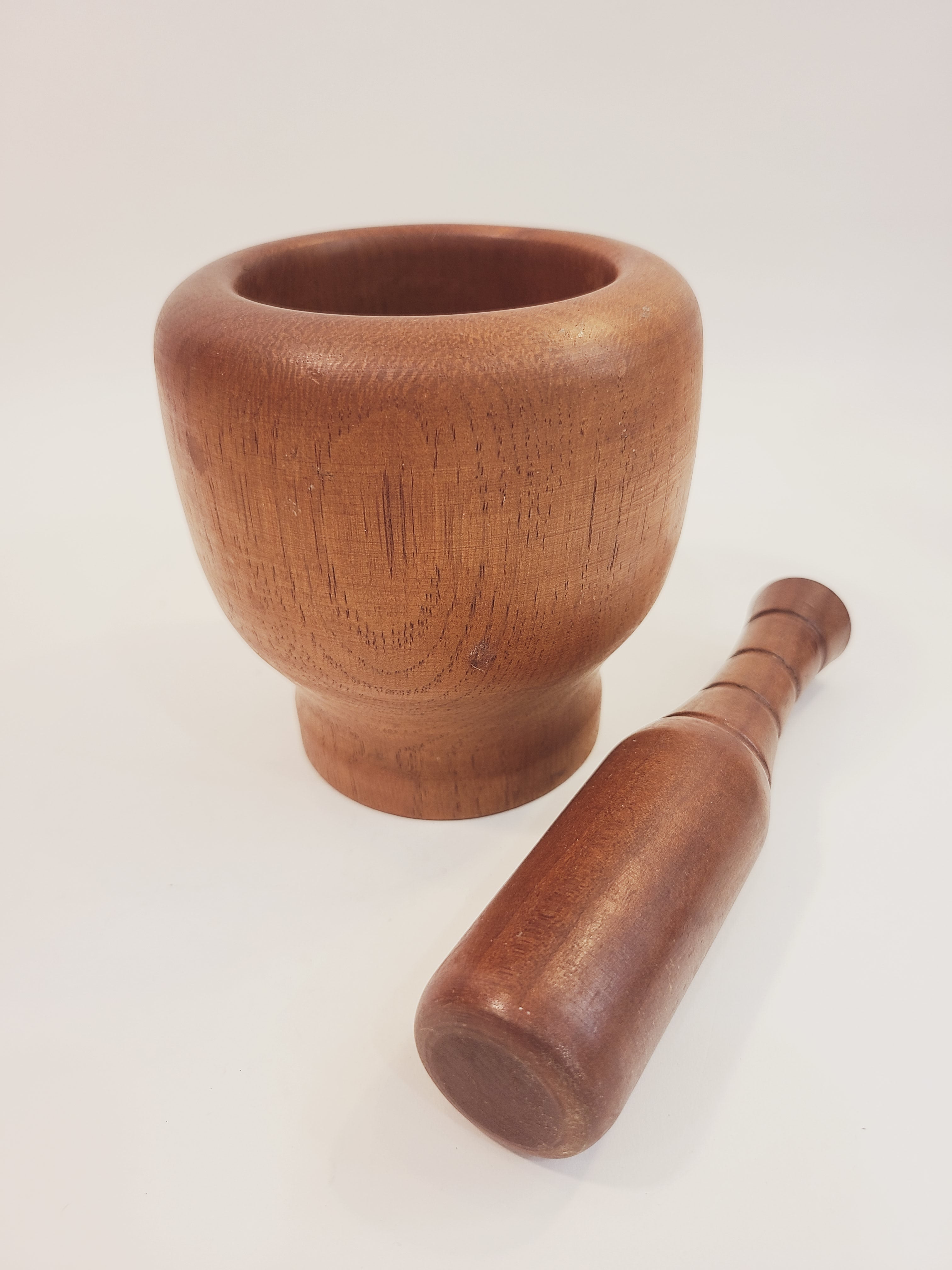 Antique Turned Wood Mortar and Pestle, Mortar 4.25 inches high by 4.25 inches diameter; Pestle 6 inches high, shown with pestle laying next to mortar. 