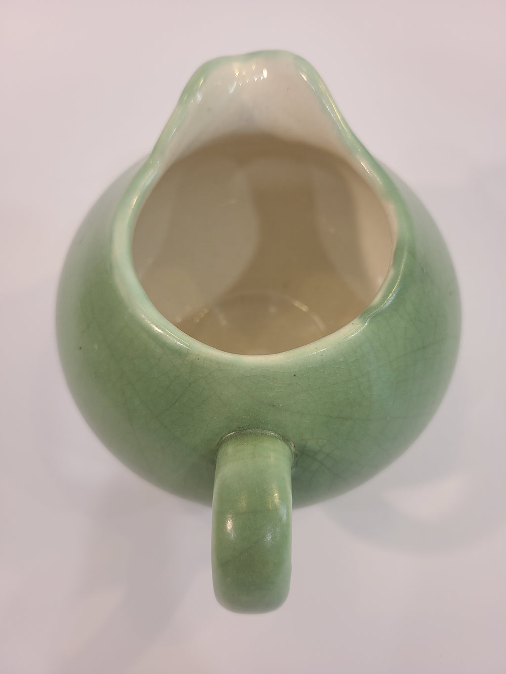 Celadon ceramic Creamer 3.5 inches high made in Vietnam shown from above.