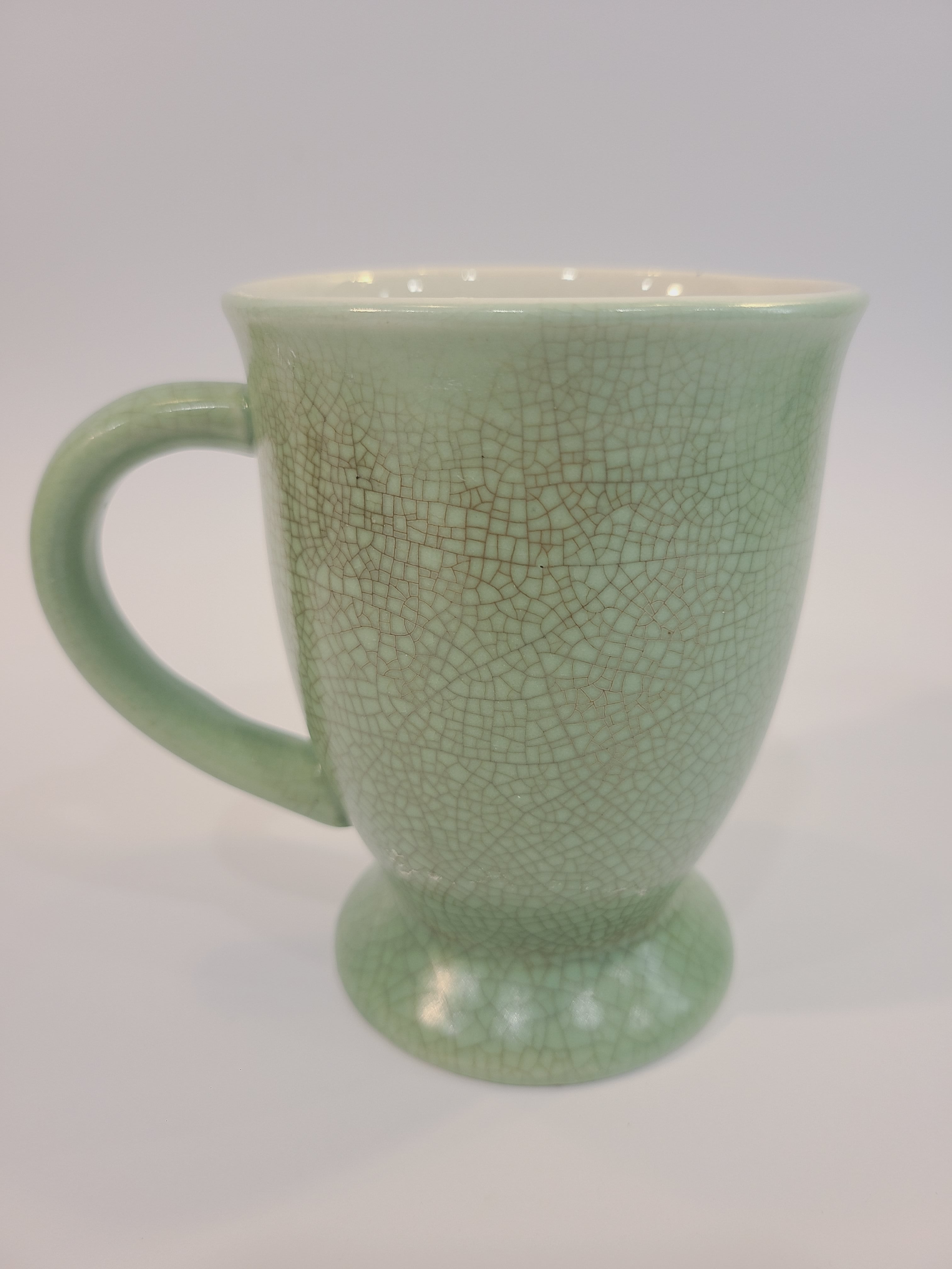 Celadon ceramic mug 4.5 inches high made in Vietnam. showing heavy crazing.