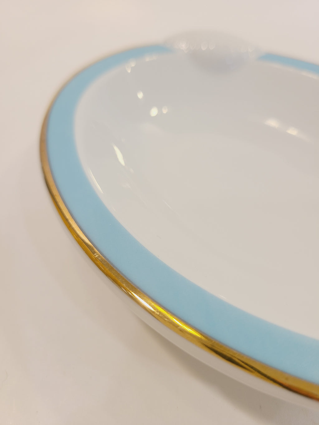 Close up of rim of Ben Rickert Fine China Dish with Seashell Embossed Rim and aqua and gold trim 1980s