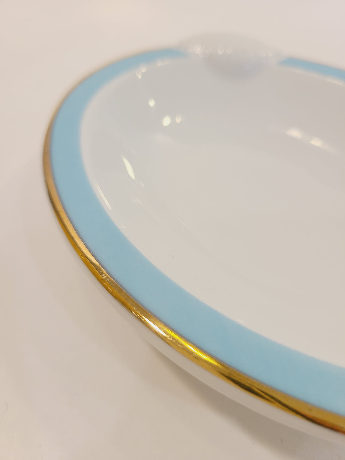 Close up of rim of Ben Rickert Fine China Dish with Seashell Embossed Rim and aqua and gold trim 1980s