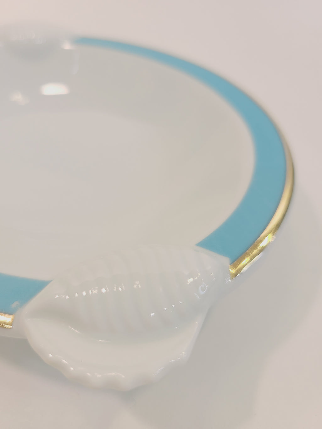 Close up of embossed shell on Ben Rickert Fine China Dish with and aqua and gold trim 1980s