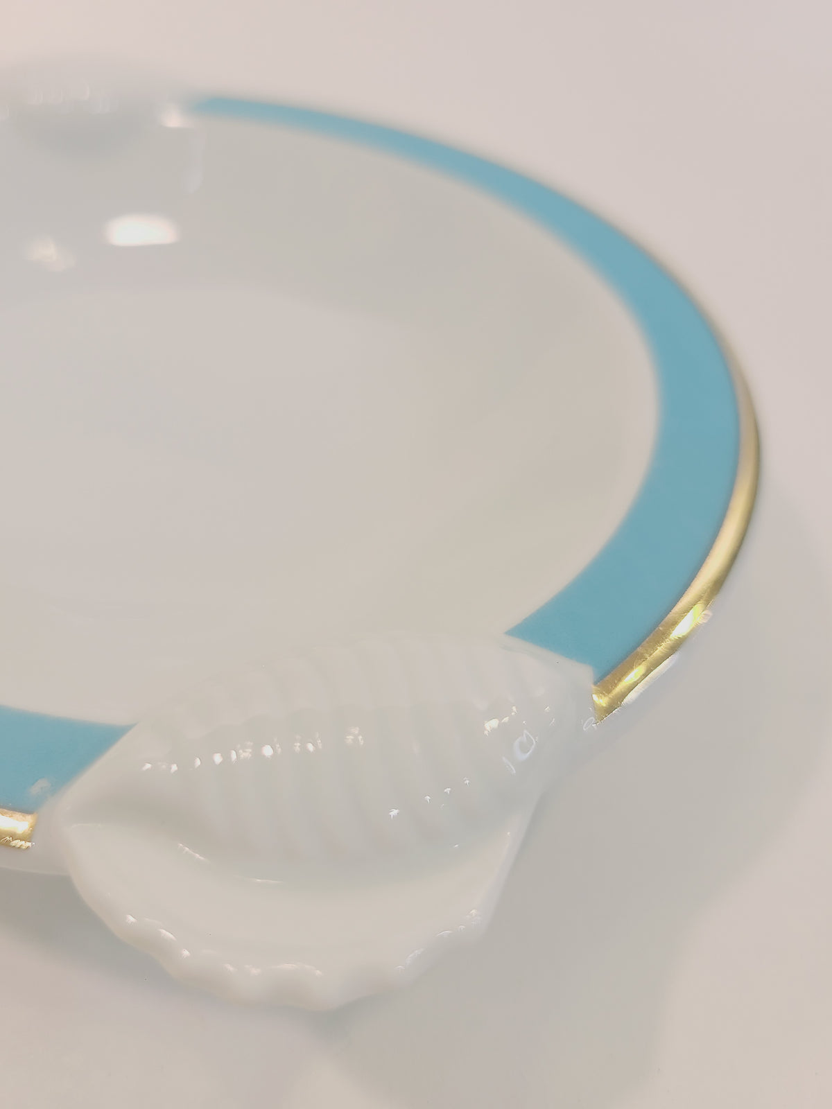 Close up of embossed shell on Ben Rickert Fine China Dish with and aqua and gold trim 1980s
