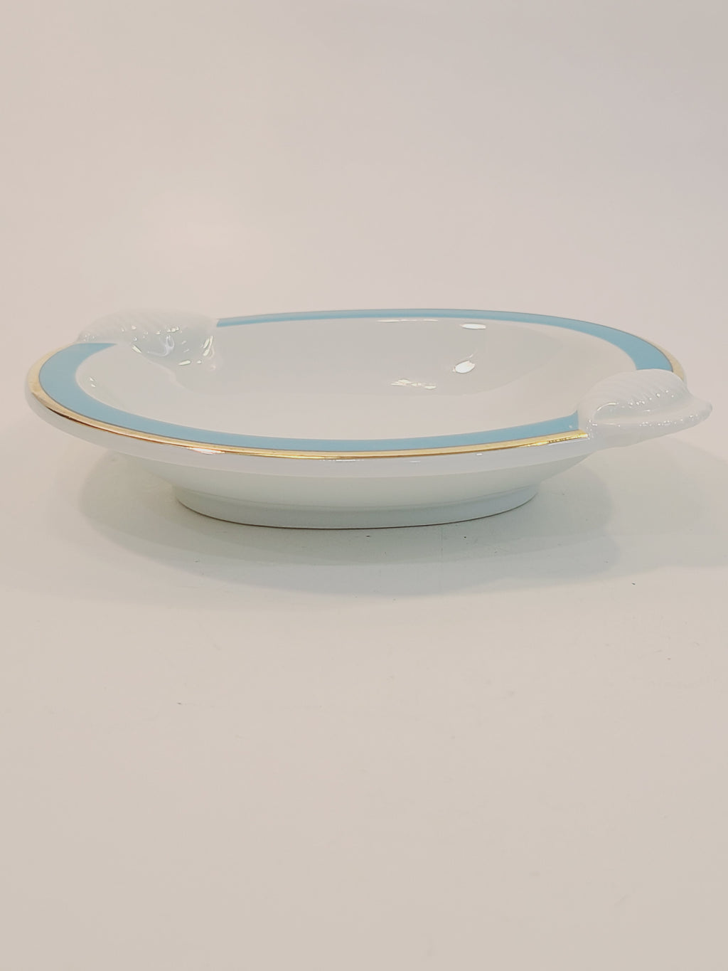 Side view of Ben Rickert Fine China Dish with Seashell Embossed Rim and aqua and gold trim 1980s