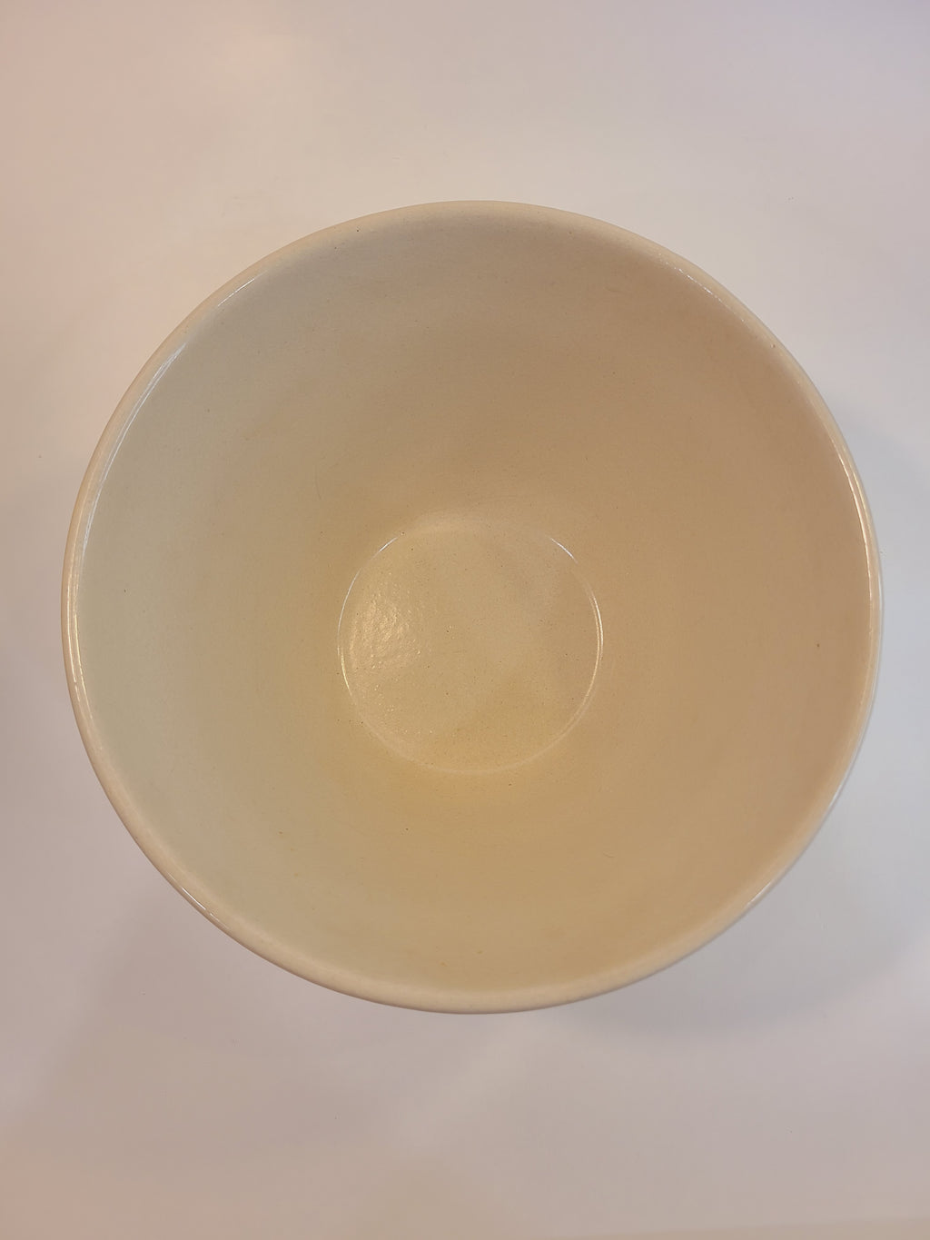 Interior of Robinson Ransbottom stoneware mixing bowl showing smooth off-white glazed interior, vintage American pottery