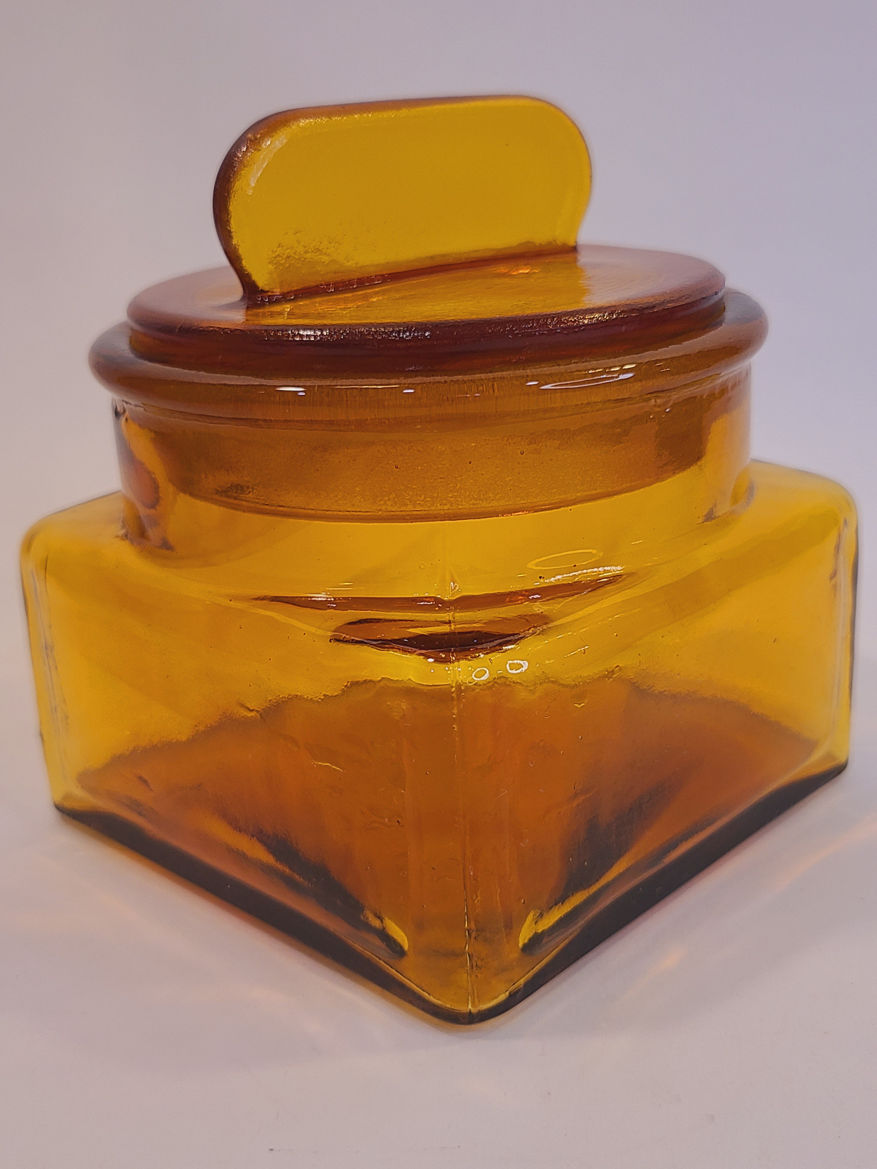 Angle view of Antique Dakota Square Amber Glass Apothecary Jar 1890s with lid