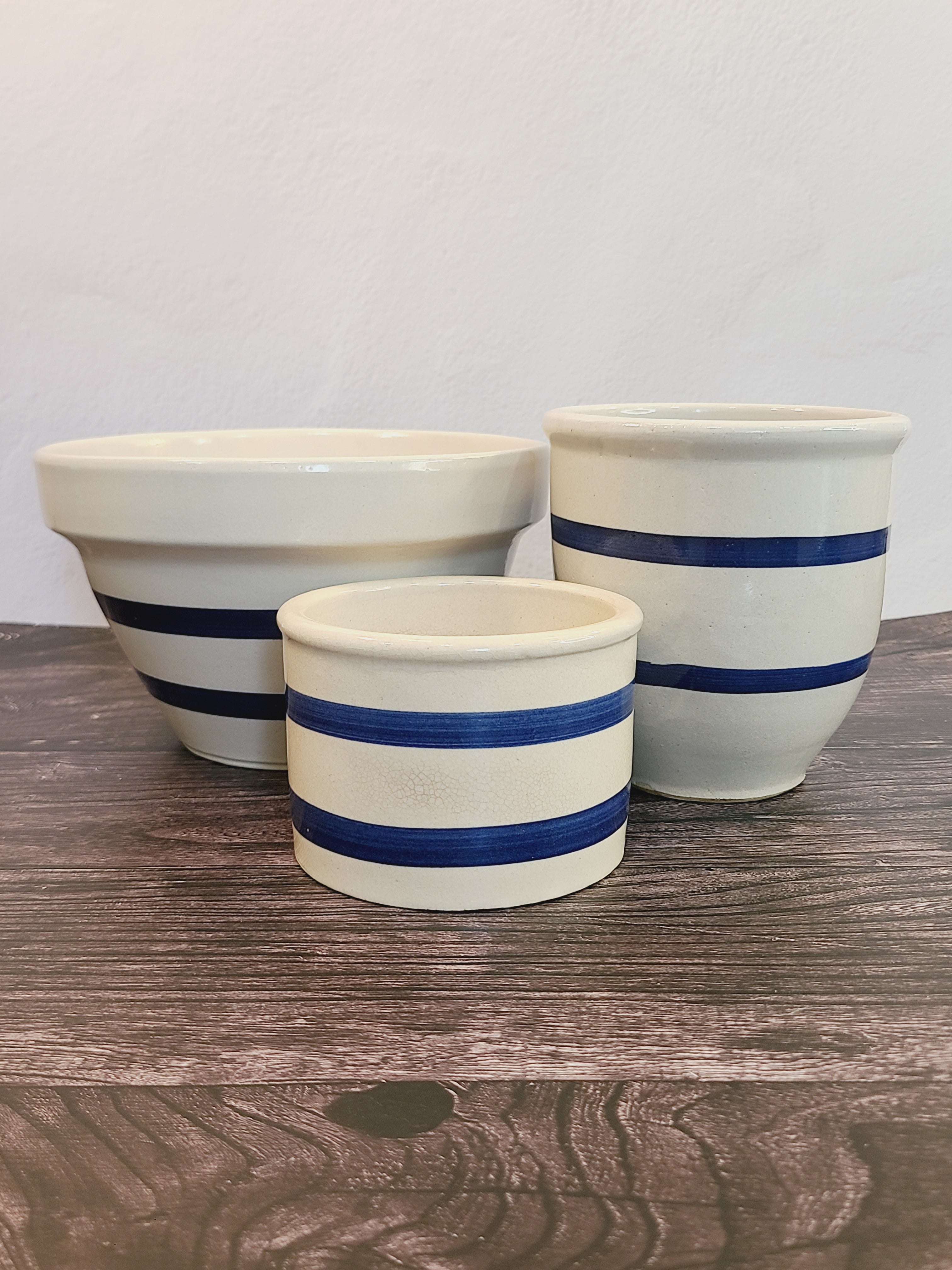 Robinson Ransbottom blue and white stoneware collection — mixing bowl, crock, and canister styled on wood surface, vintage Ohio pottery