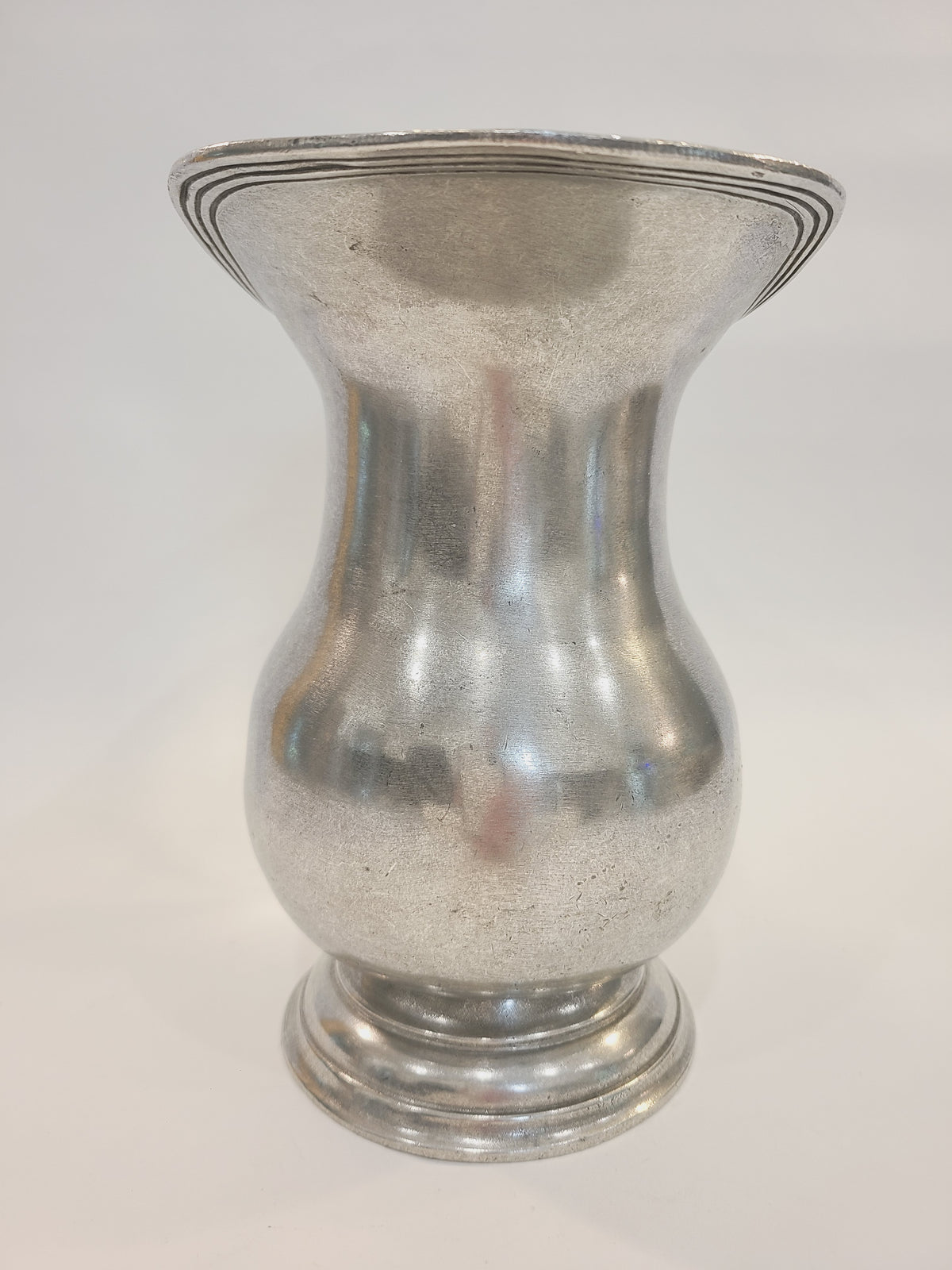 Front view of vintage 95% real pewter pitcher showing baluster body, flared rim, and concentric lathe lines on stepped foot, late 1970s–1980s