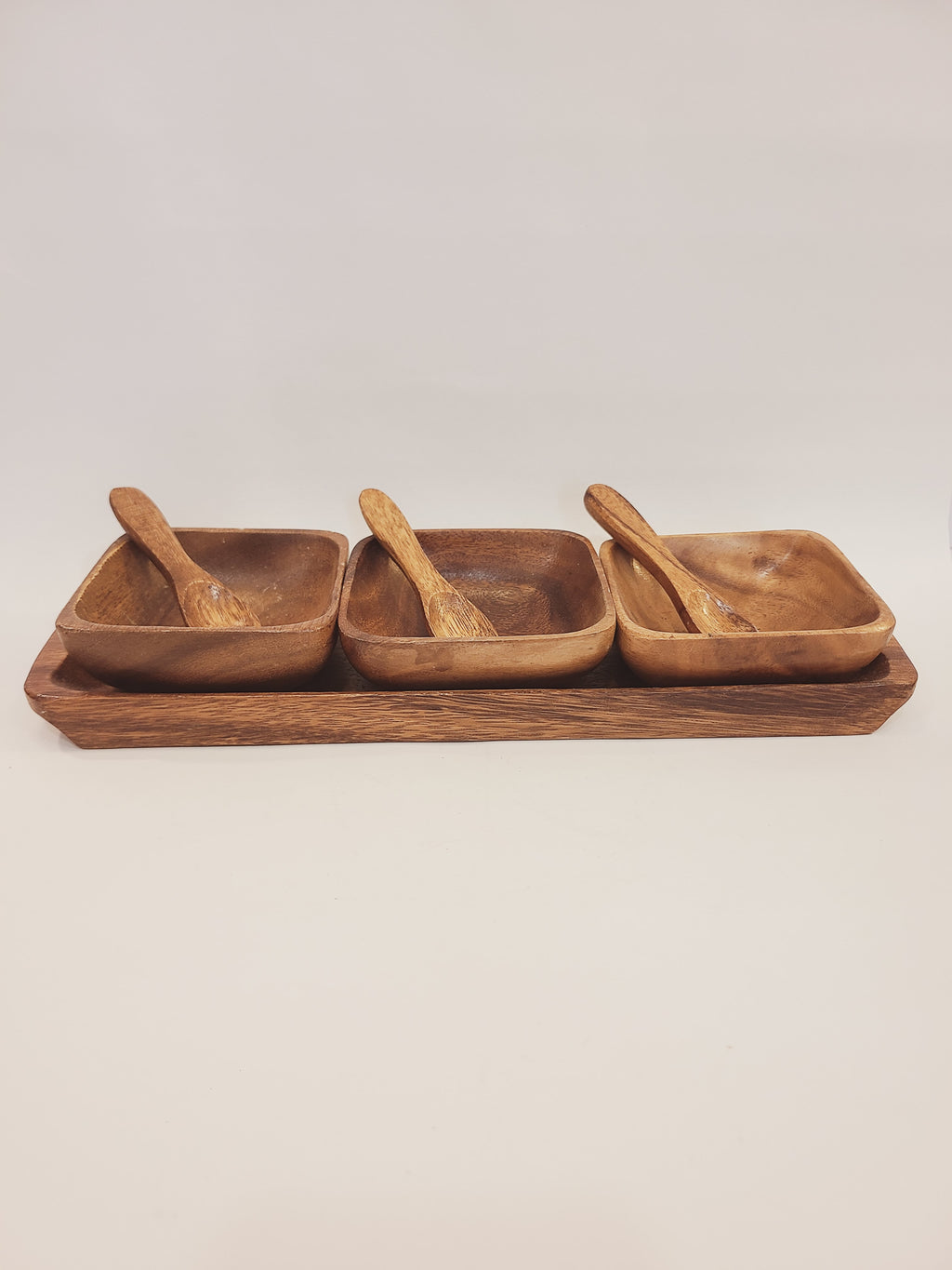 7-piece mid-century monkey pod wood serving set with rectangular tray, three square bowls, and carved spoons, Philippines circa 1950s–1960s