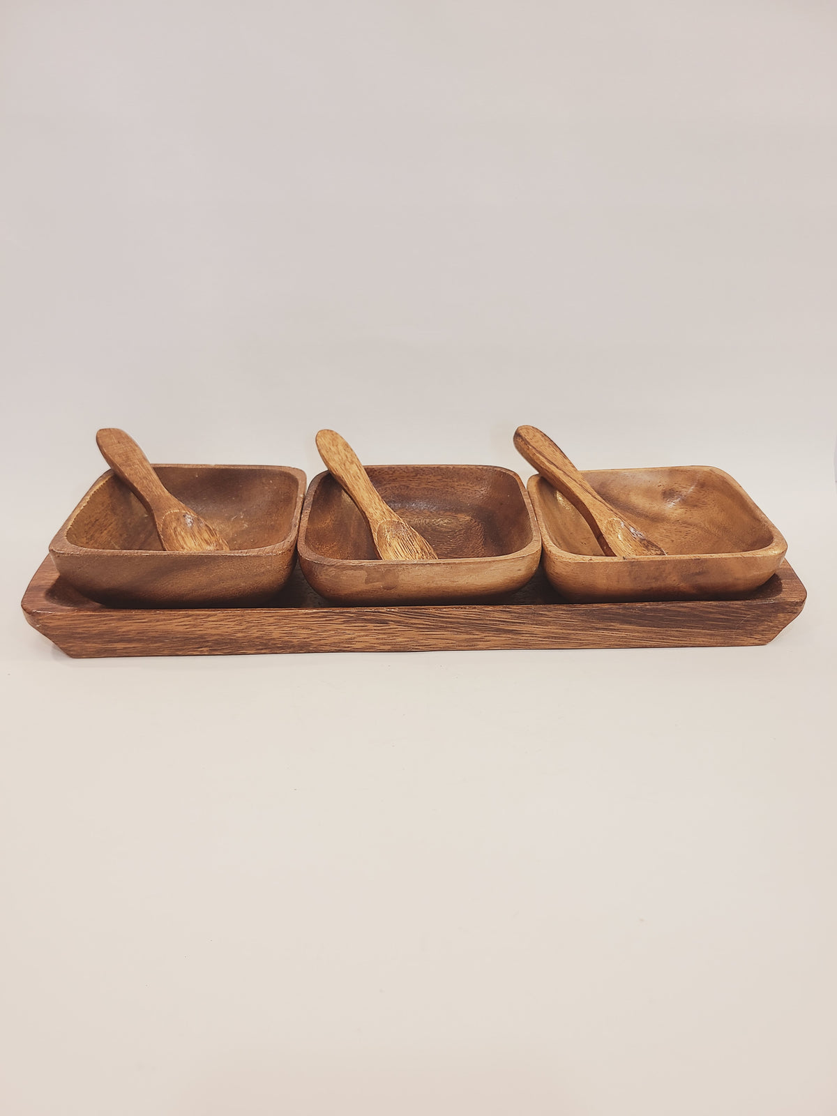 7-piece mid-century monkey pod wood serving set with rectangular tray, three square bowls, and carved spoons, Philippines circa 1950s–1960s