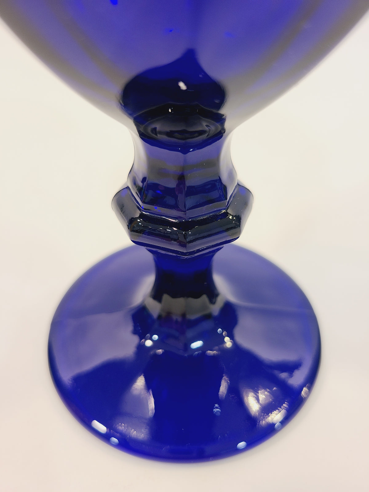 Close-up of Libbey Gibraltar cobalt blue goblet faceted stem and round base, architectural angular detail of vintage Duratuff USA barware