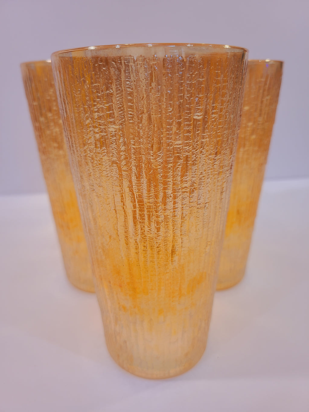 Close-up of Jeannette Glass Marigold carnival glass showing deeply molded Tree Bark texture and iridescent metallic luster, Depression-era collectible glassware