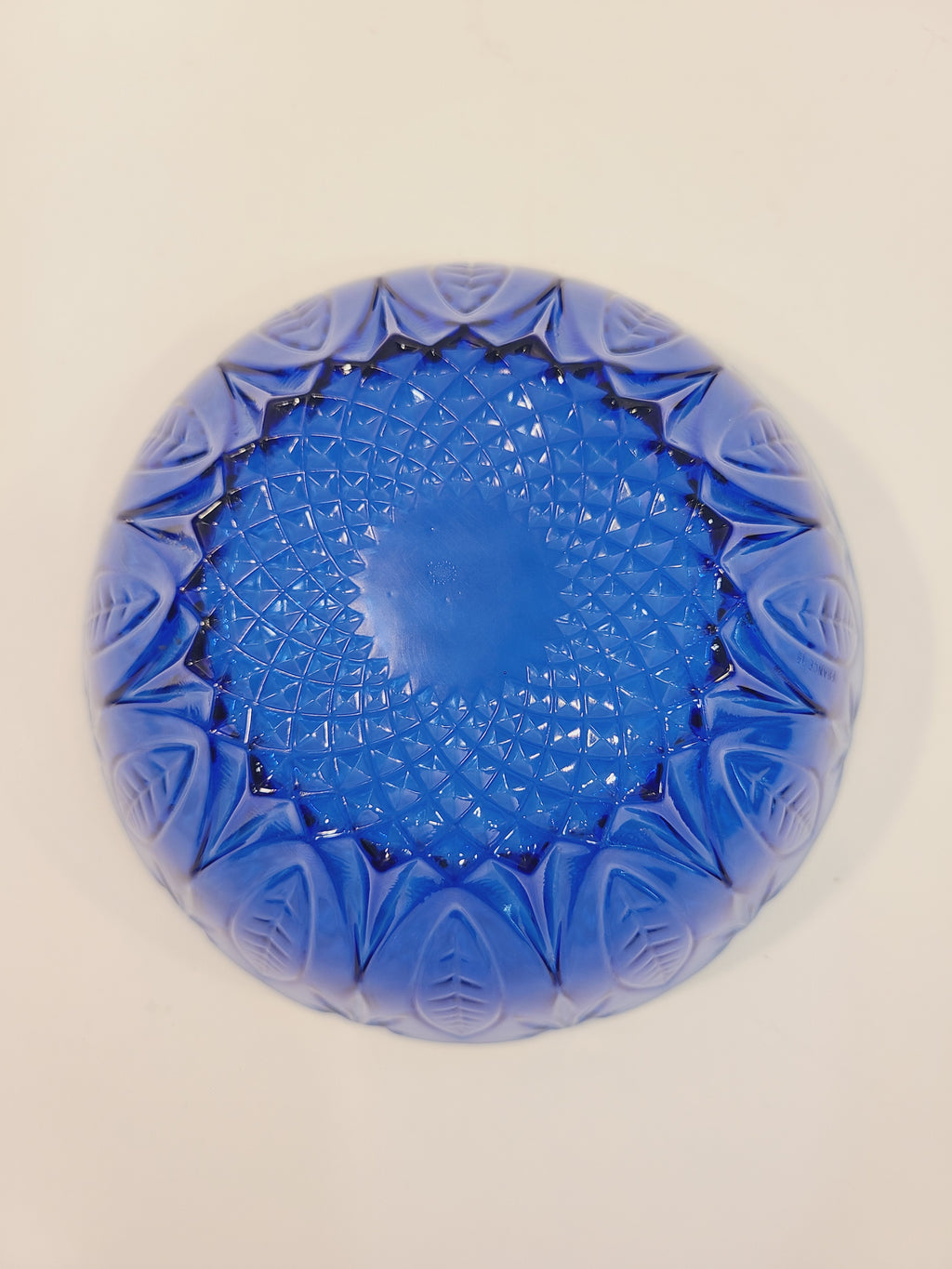 Bottom of Avon Royal Sapphire cobalt blue glass bowl showing diamond-optic starburst pattern — vintage France