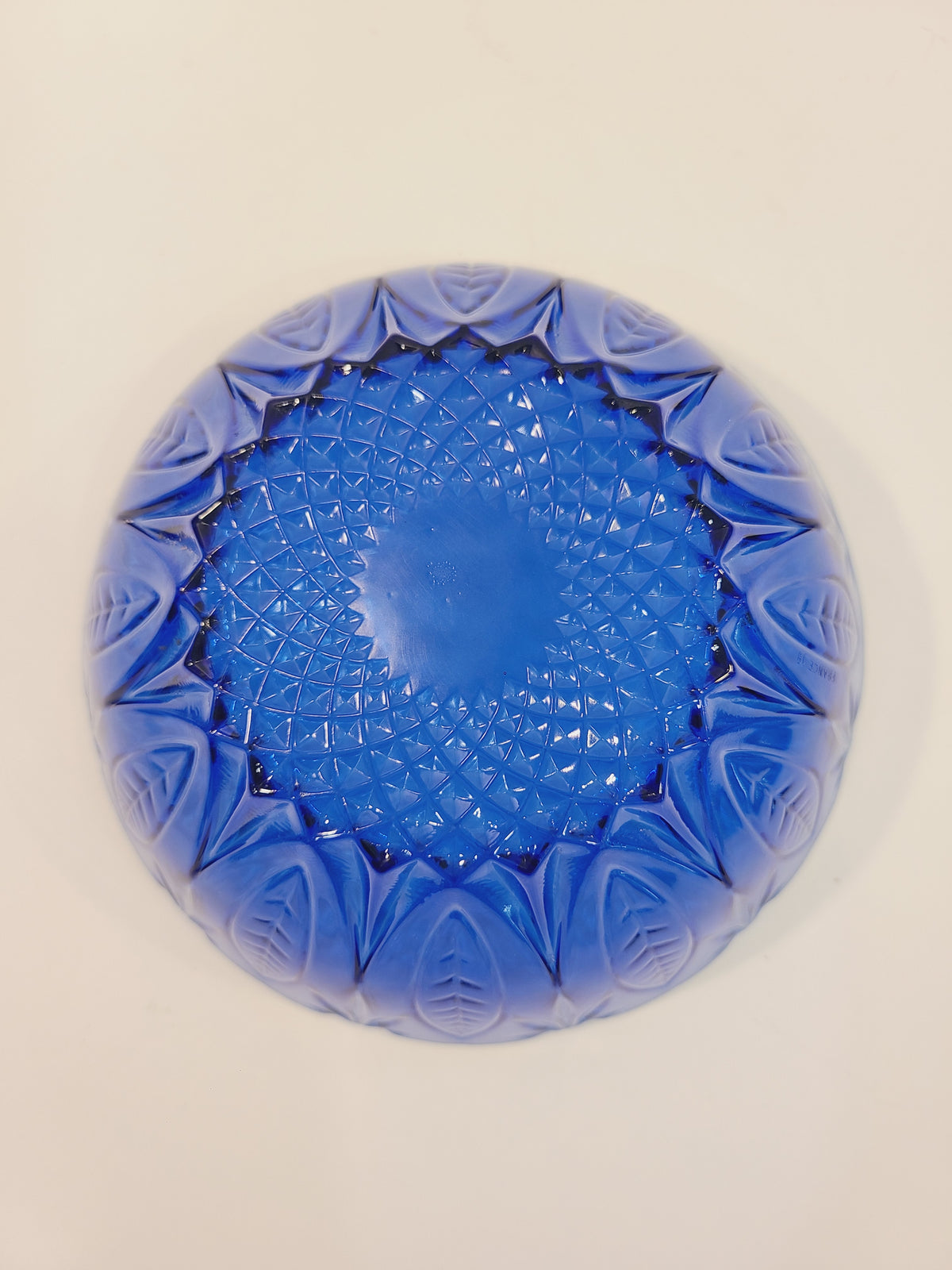 Bottom of Avon Royal Sapphire cobalt blue glass bowl showing diamond-optic starburst pattern — vintage France