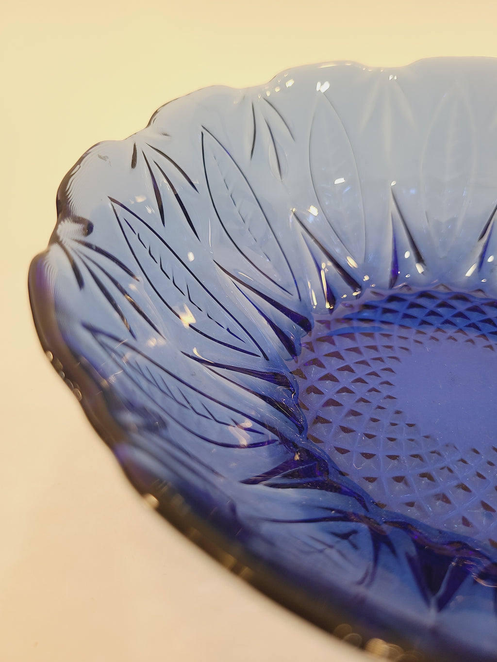 Close-up of embossed leaf rim and diamond-optic interior on Avon Royal Sapphire cobalt blue glass bowl — vintage France