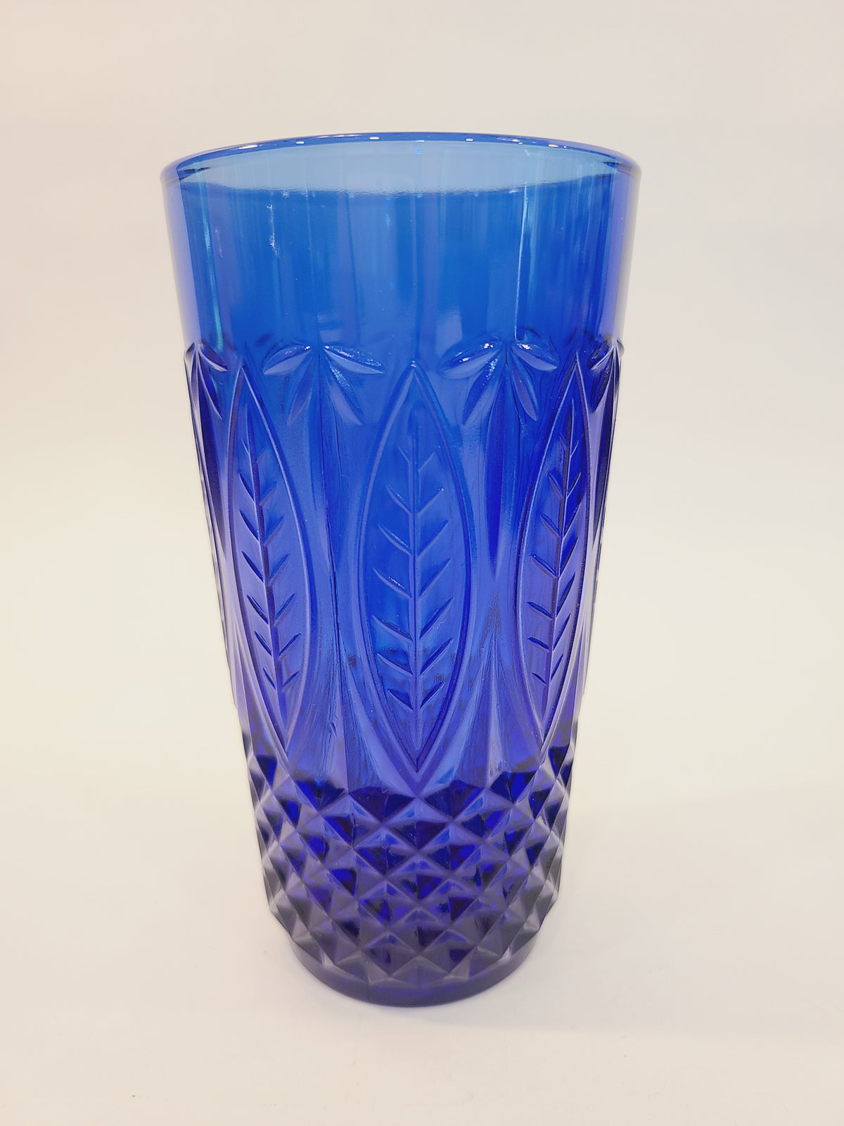 Avon Royal Sapphire cobalt blue highball glass, full view showing embossed leaf and diamond-optic pattern — vintage France