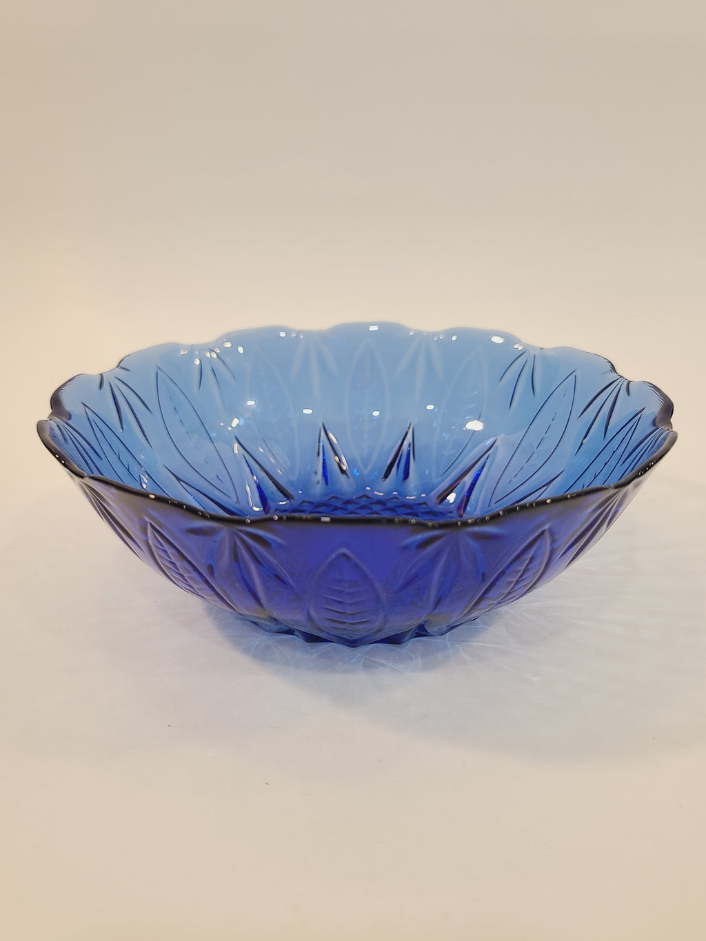 Avon Royal Sapphire cobalt blue glass soup bowl, angled view showing embossed leaf rim and diamond-optic texture — France