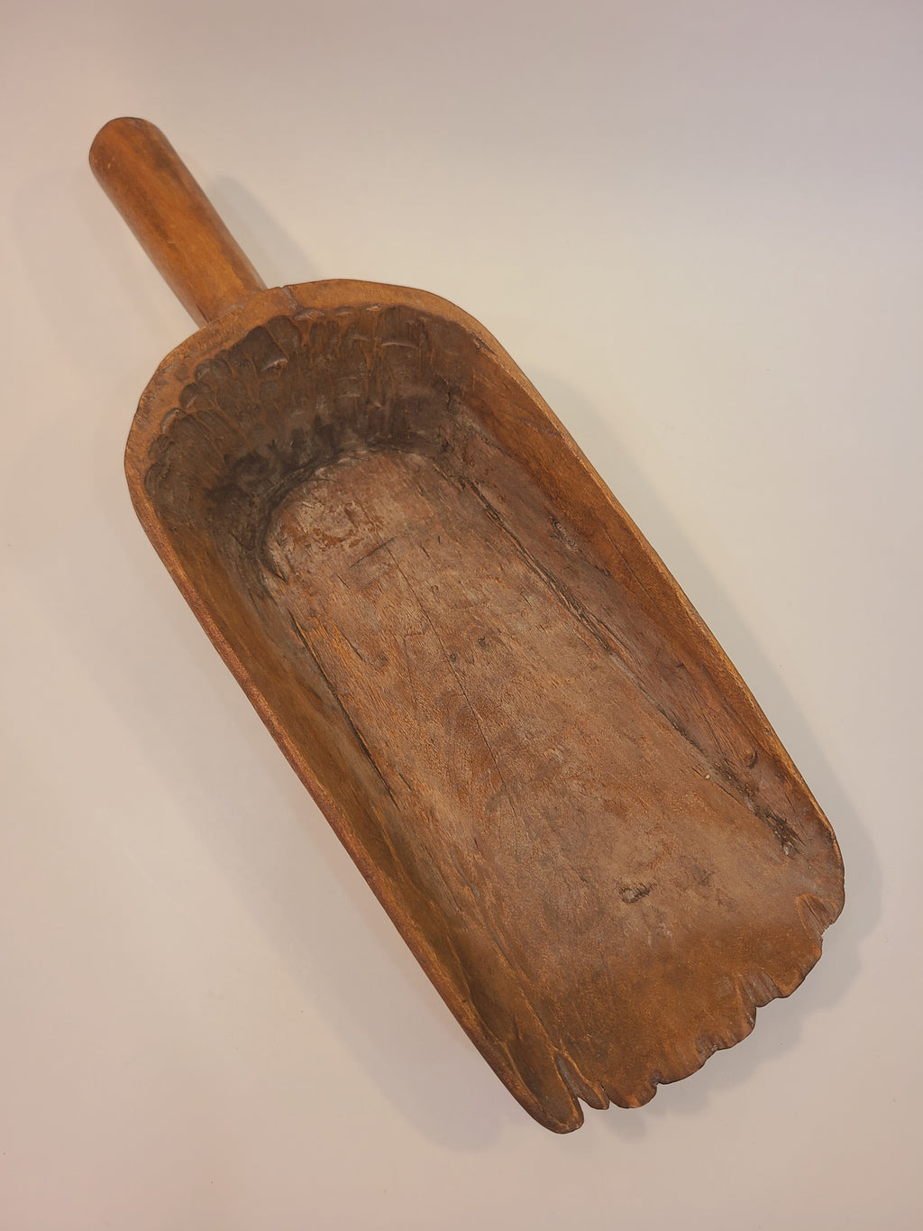 Antique hand-carved hardwood grain scoop, top view showing deep bowl and turned handle — late 19th century treenware