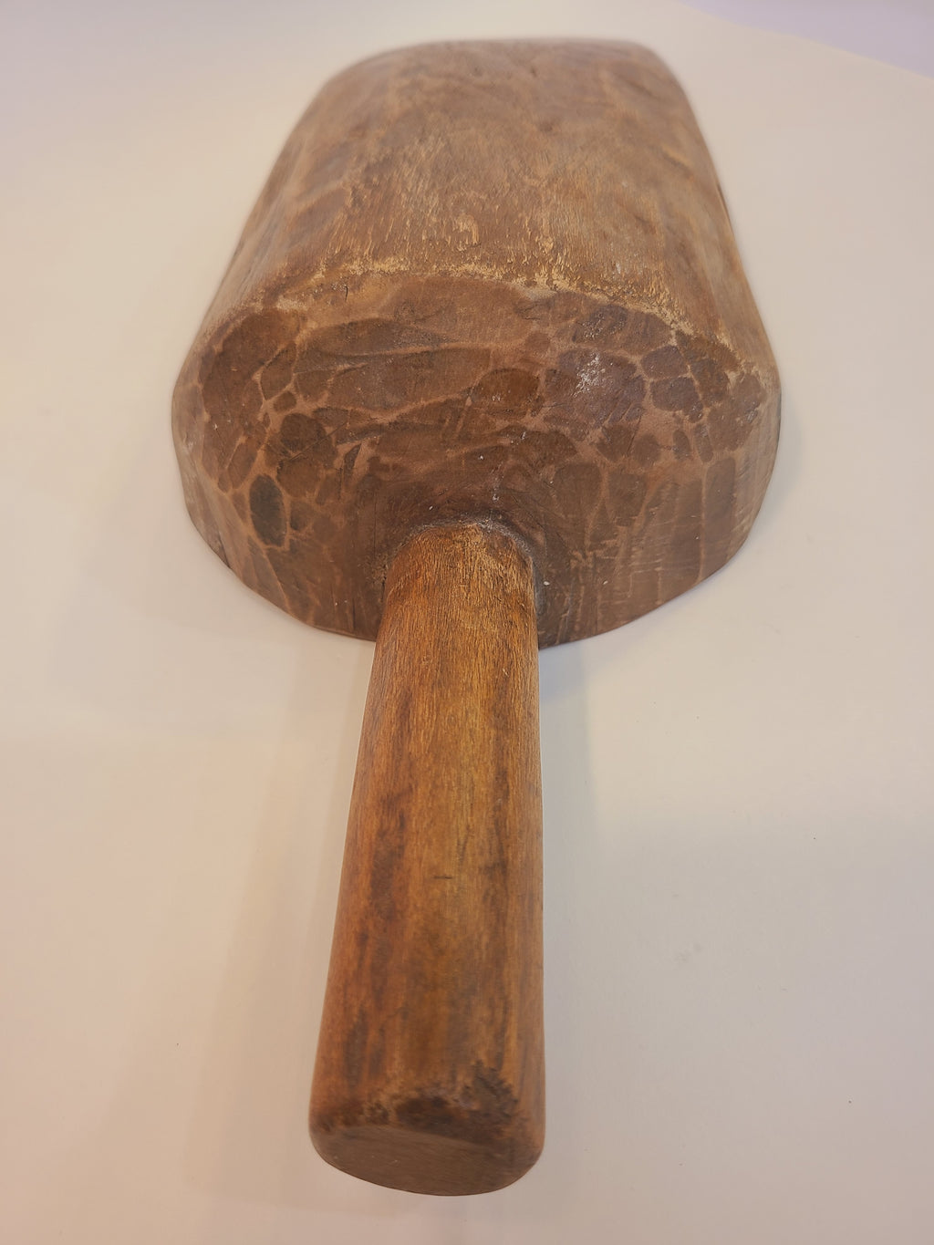 Close-up of handle of antique hand-carved hardwood grain scoop — authentic 19th century use-wear
