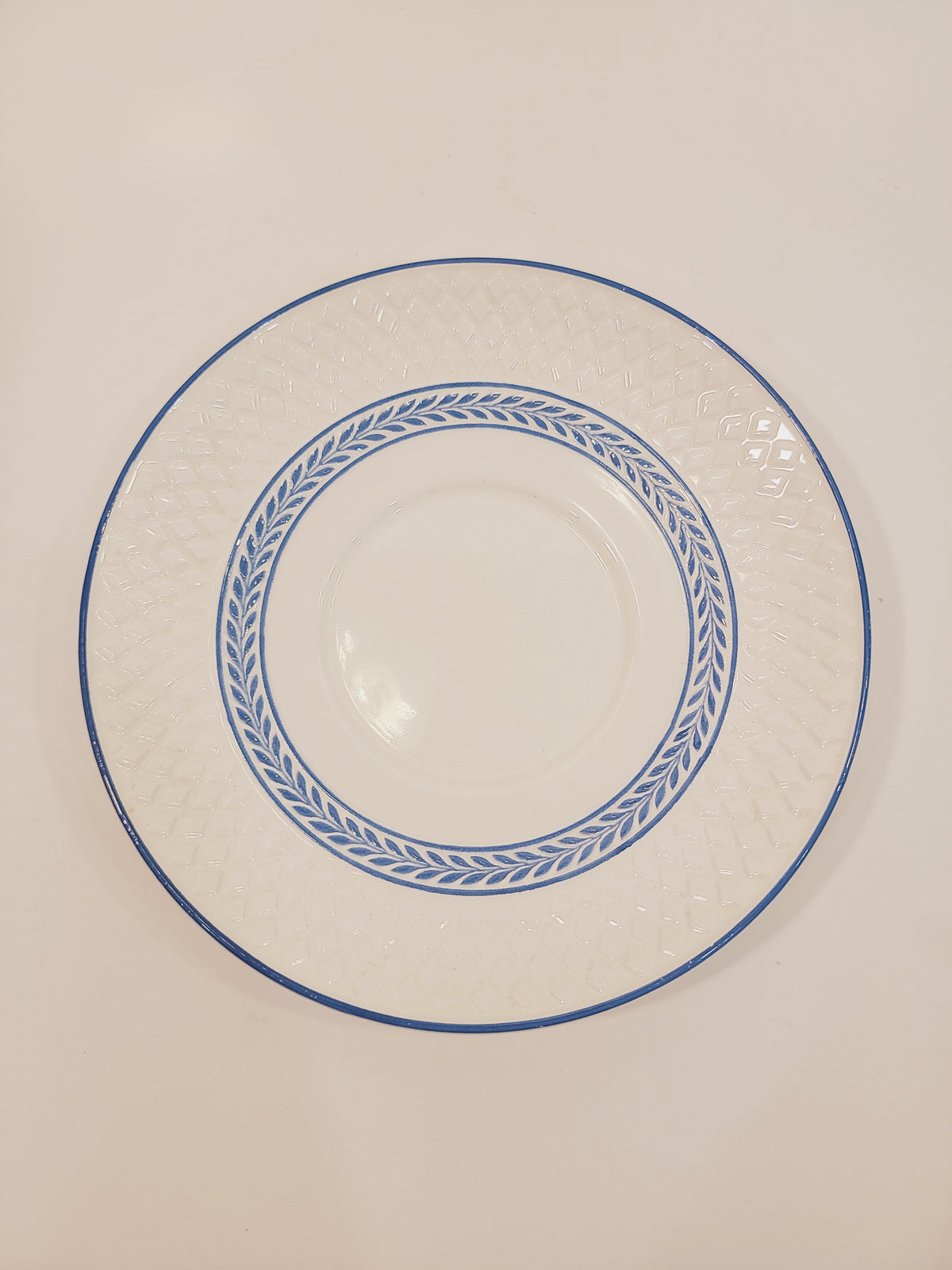 Overhead view of Copeland Spode Elaine Mansard underplate showing soft blue laurel vine pattern and embossed diamond rim