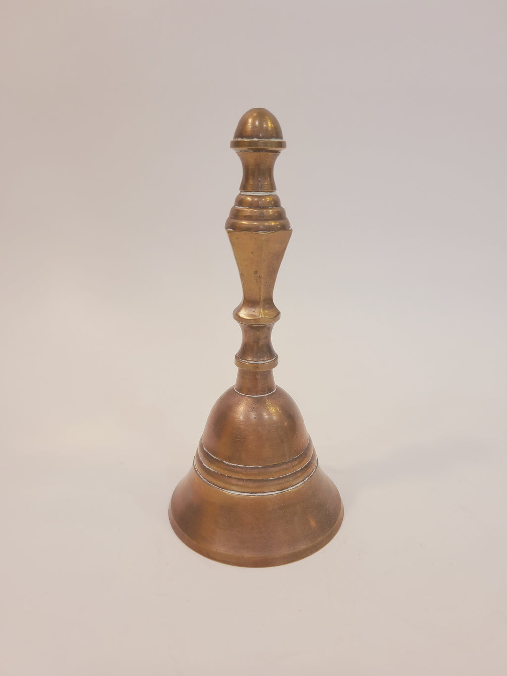 Vintage solid red brass hand bell with turned baluster handle, full front view — coastal farmhouse decor