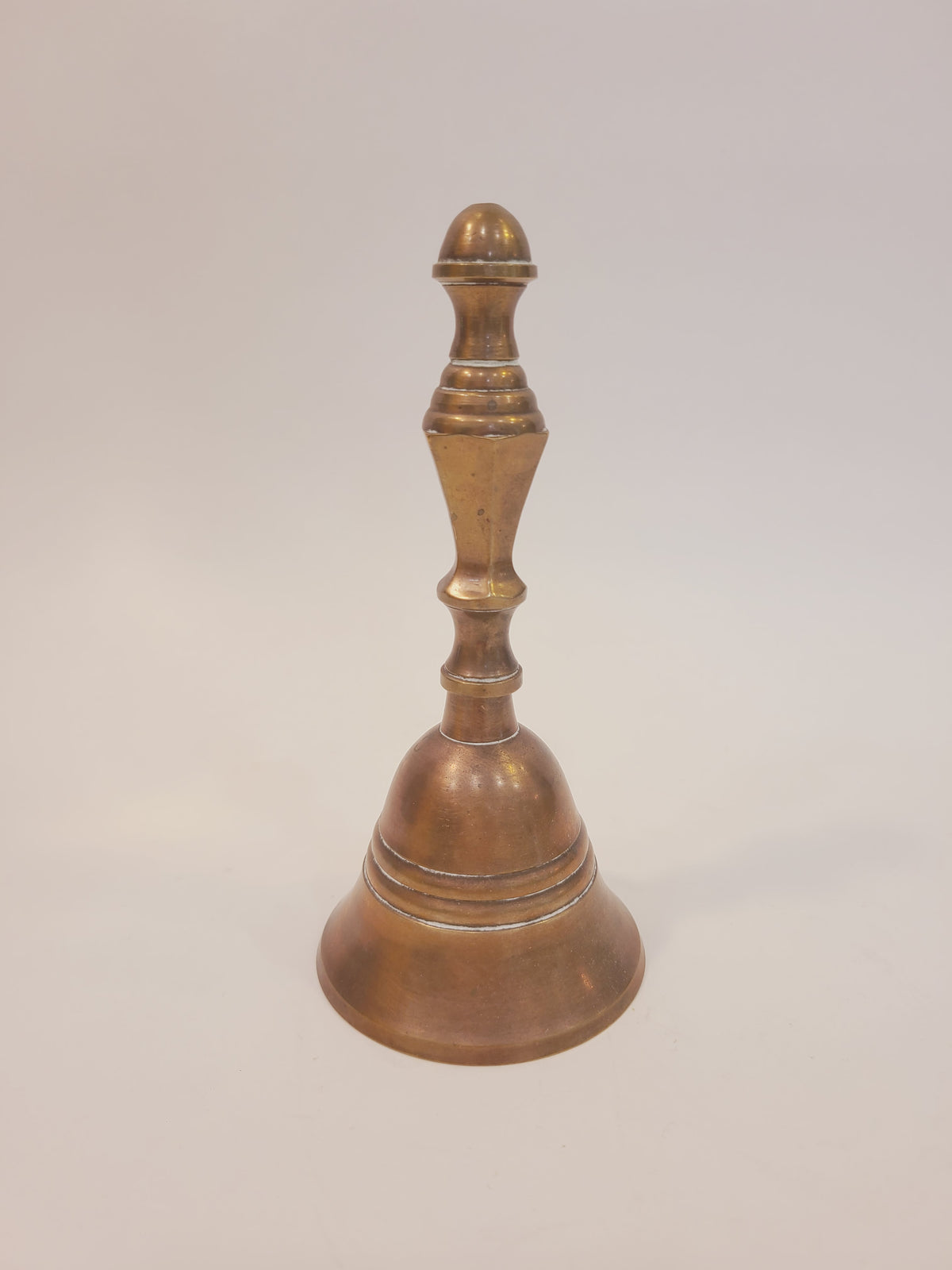 Vintage solid red brass hand bell with turned baluster handle, full front view — coastal farmhouse decor