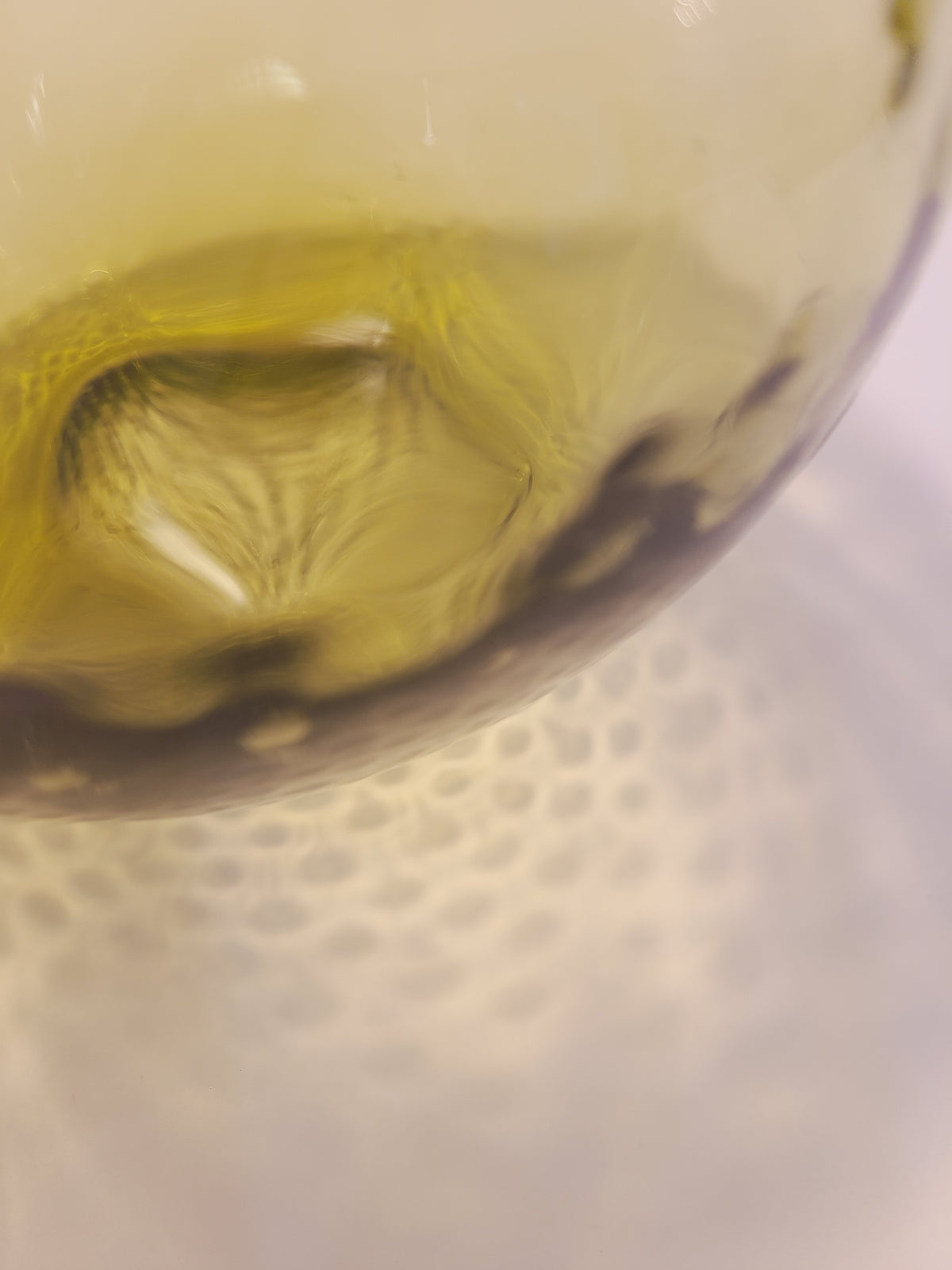 Olive green handblown glass pitcher base showing light refraction through optic dimple texture — vintage art glass