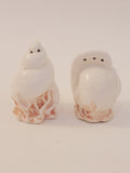 Fitz and Floyd Coquille seashell salt and pepper shaker set, white ceramic moon snail and conch shell forms on pink coral bases, vintage 1970s–1980s coastal decor