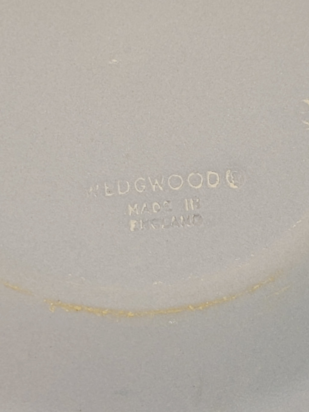 Underside of Wedgwood jasperware pin plate showing incised Wedgwood Made in England stamp, authentication mark on vintage Cancer zodiac crab plate